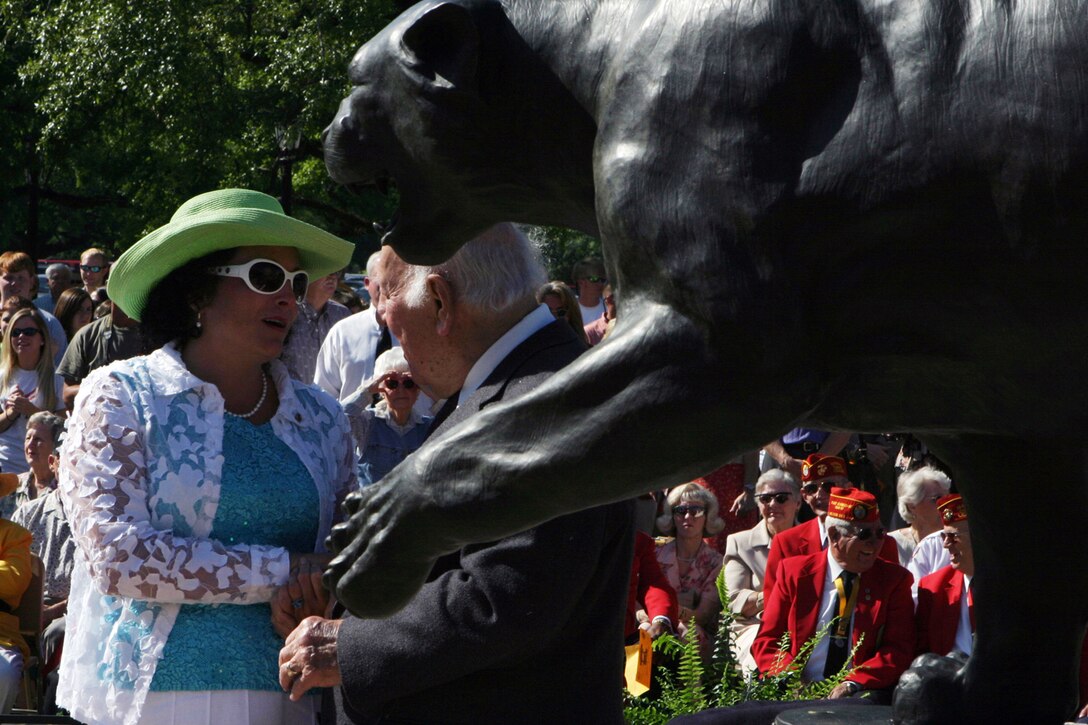 Kathleen Faircloth, mother of Lance Cpl. Bradley M. Faircloth, a Marine killed in Fallujah, Iraq, in 2004, helps unveil a statute dedicated in his honor at his high school on April 14.  Lance Cpl. Faircloth helped launch the project before enlisting in the Marine Corps.