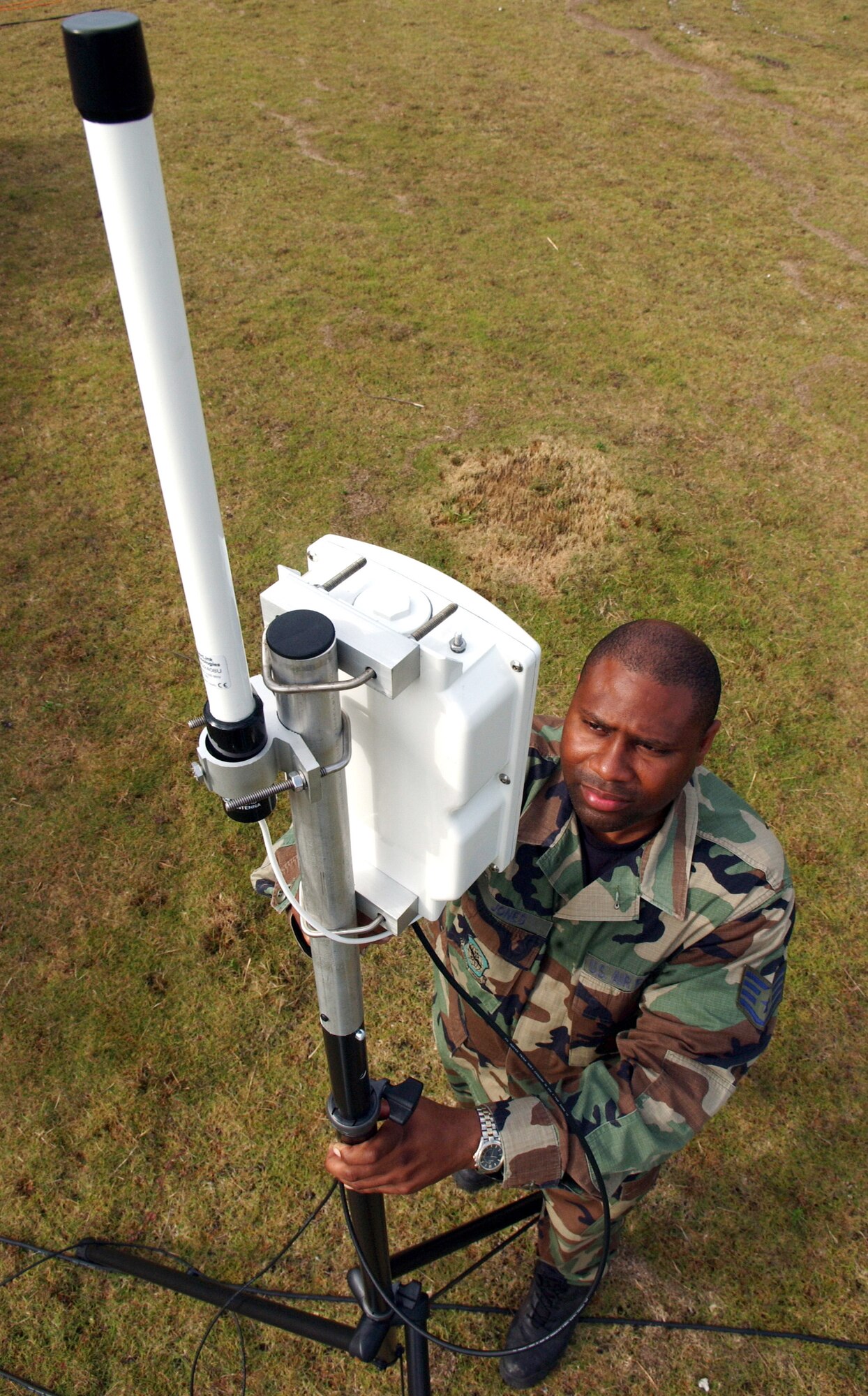 Staff Sgt. Shawn Jones checks the receiver for a voice system to allow wireless communications for Exercise Jump Start on Thursday, April 13, 2006, at Homestead Air Reserve Base, Fla. The communications exercise is designed to familiarize troops from Reserve, Guard and active military units with equipment they wouldn't normally use. Sergeant Jones is a ground radio technician with the 514th Communications Squadron at McGuire Air Force Base, N.J. U.S. Air Force photo/Airman 1st Class Bradley Lail)

