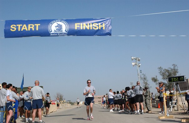 Capt. Casey Jackson crosses the finish line with a time of 3 hours, 2 minutes, 17 seconds to take second place in the 2nd Annual Boston Marathon at Ali Base, Iraq, on Saturday, April 15, 2006. Captain Jackson is deployed to the 407th Expeditionary Operations Support Squadron from Ramstein Air Base, Germany. (U.S. Air Force photo/Master Sgt. Jon Hanson)