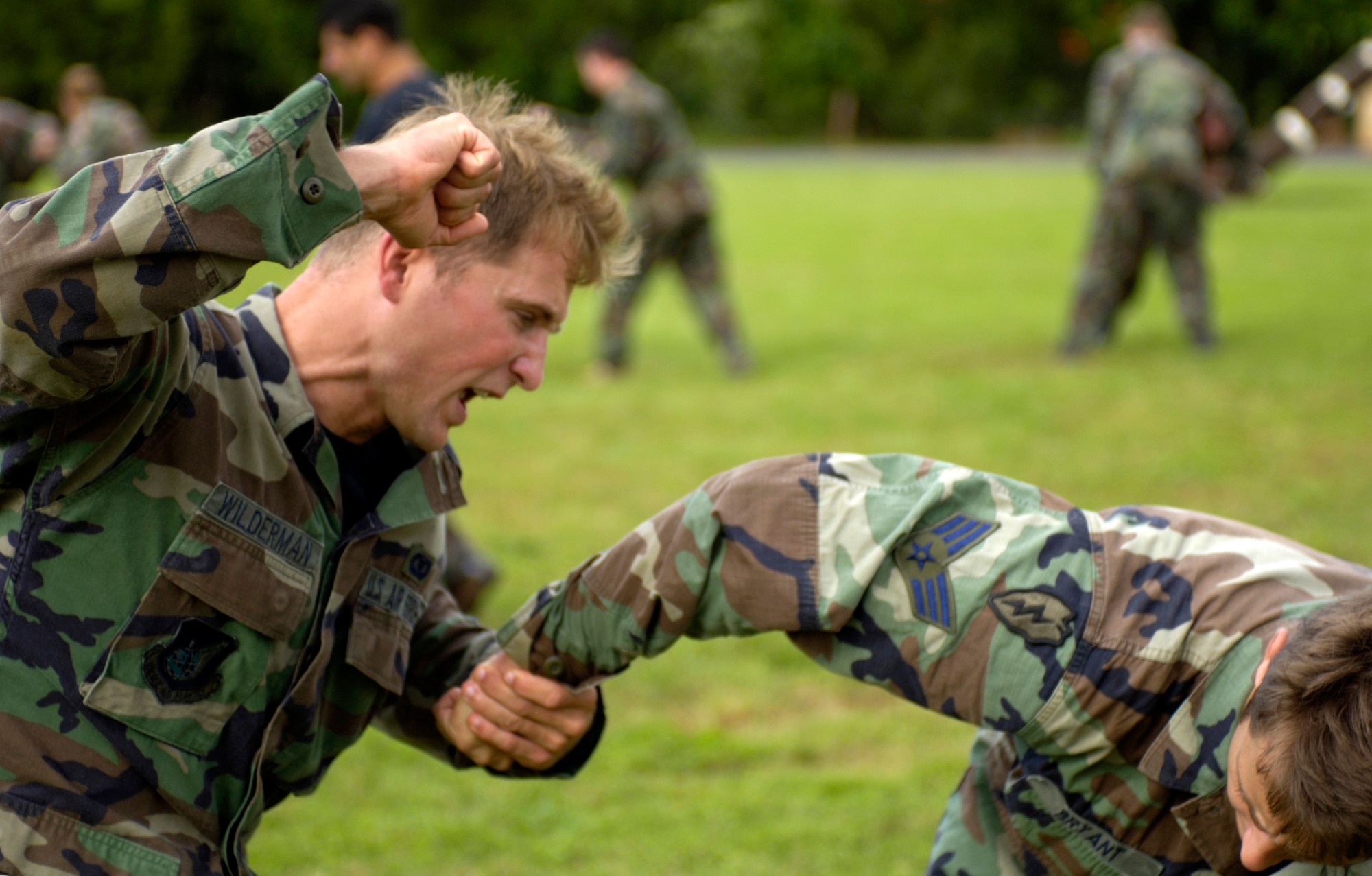 Senior Airmen Glenn Wilderman and Nathanial Bryant practice close-combat skills at Wheeler Army Air Field, Hawaii, on Thursday,  April 13, 2006. The Airmen are tactical air controllers from the 25th Air Support Operations Squadron. (U.S. Air Force photo/Tech. Sgt. Shane A. Cuomo)