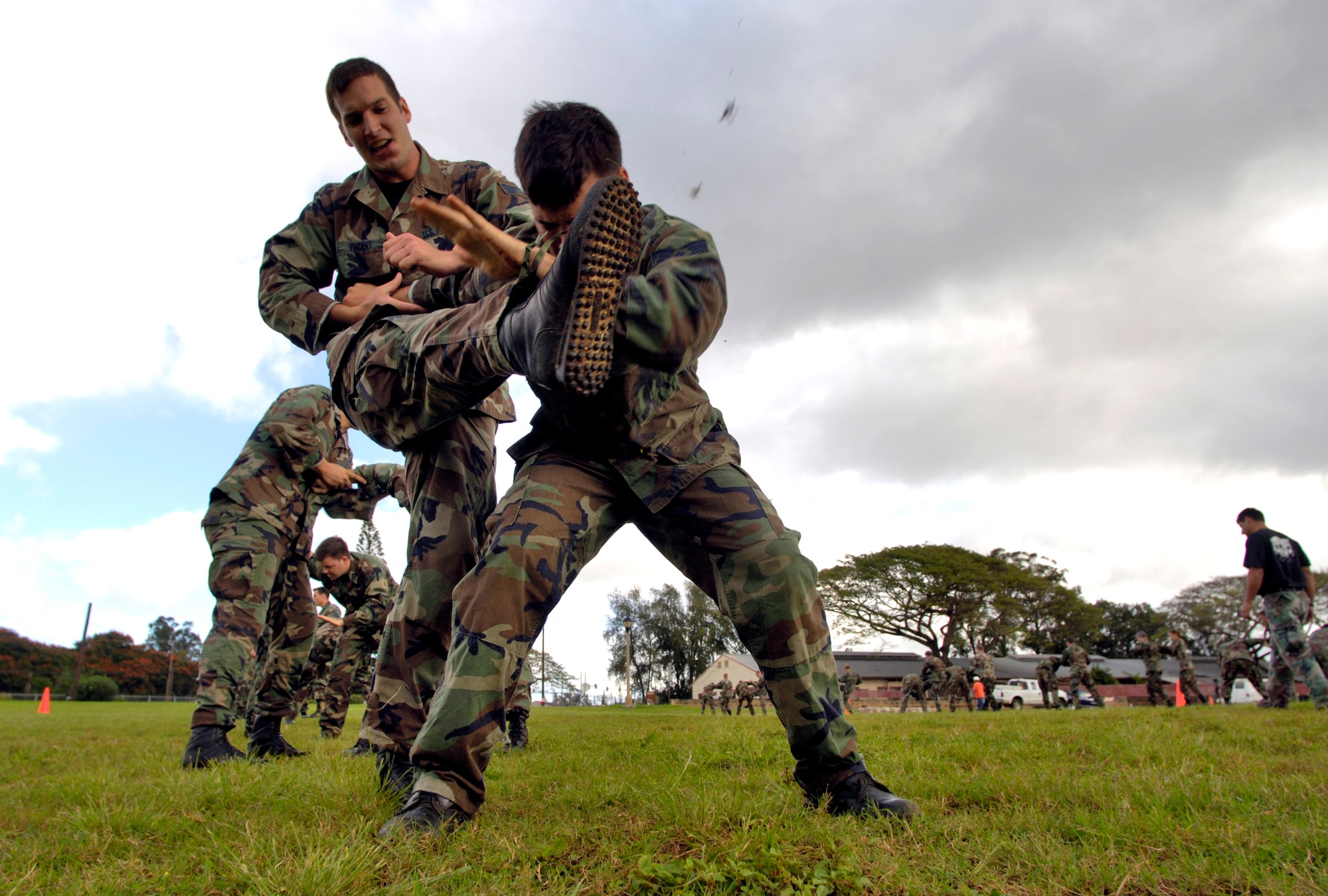 Staff Sgt. George Earhart protects his face from a kick from Senior Airman Justin Vincent during close-combat skills training Thursday, April 13, 2006, at Wheeler Army Air Field, Hawaii. Airman Vincent and Sergeant Earhart are tactical air controllers from the 25th Air Support Operation Squadron. (U.S. Air Force photo/Tech. Sgt. Shane A. Cuomo)