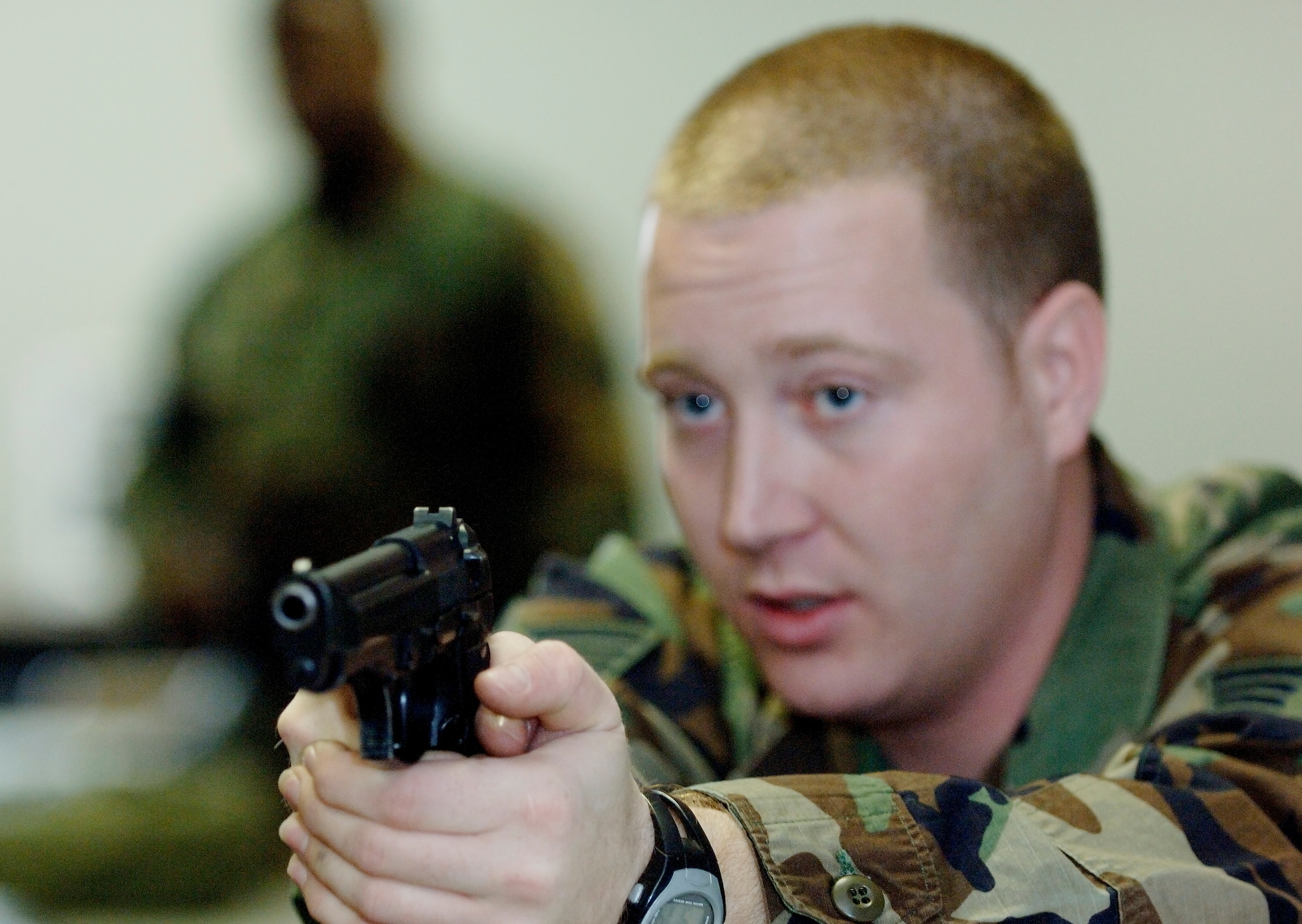 Staff Sgt. Francis Wilkinson, 1st Security Forces Squadron Combat Arms, instructs an M-9 Beretta handgun course in the classroom prior to stepping out to the firing range. Team Langley members train on the M-9 Beretta handgun and the M-4 assault rifle at the Combat Arms Training and Maintenance (CATM) course on Dec. 14, 2005 at Langley Air Force Base, Virginia. (U.S. Air Force photo by Staff Sgt. Verlin Levi Collins)