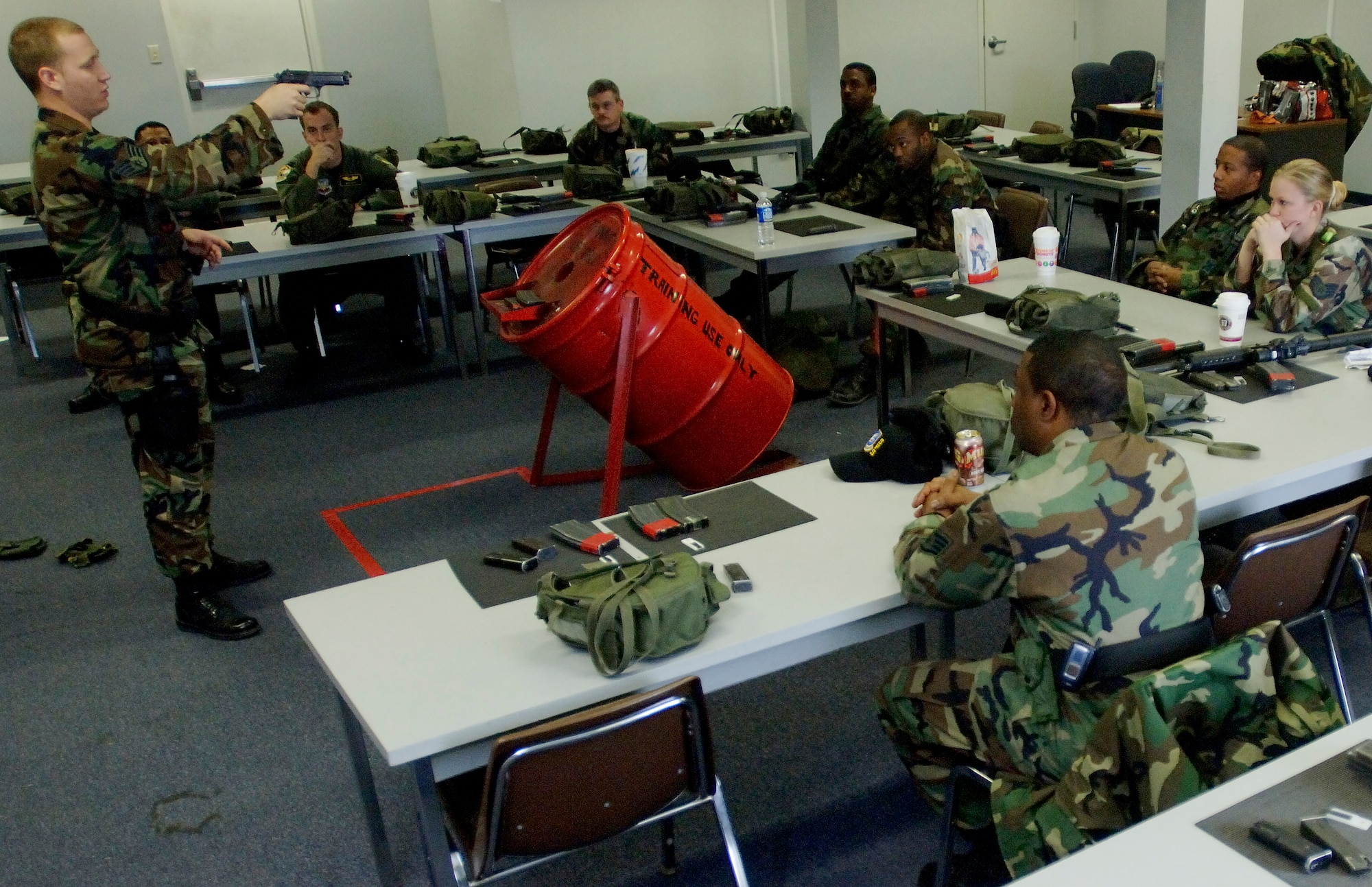 Staff Sgt. Francis Wilkinson, 1st Security Forces Squadron Combat Arms, instructs an M-9 Beretta handgun course in the classroom prior to stepping out to the firing range. Team Langley members train on the M-9 Beretta handgun and the M-4 assault rifle at the Combat Arms Training and Maintenance (CATM) course on Dec. 14, 2005 at Langley Air Force Base, Virginia. (U.S. Air Force photo by Staff Sgt. Verlin Levi Collins)
