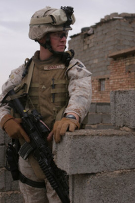 U.S. Marine Corps Cpl. Paul Bennett provides security during a patrol in the vicinity of Forward Operating Base Abu Ghraib in the Al Anbar province in Iraq on April 12, 2006. Bennett is assigned as an assaultman with Mobile Assault Platoon 3, Weapons Company, 1st Battalion, 1st Marine Regiment, 1st Marine Division. 