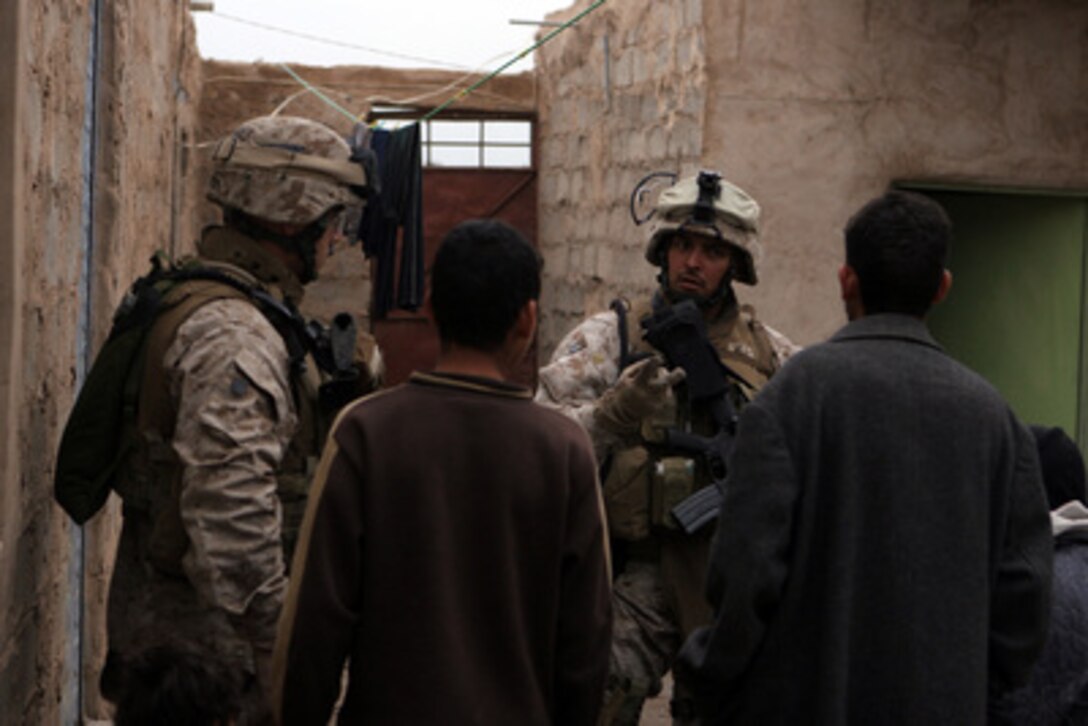 U.S. Marine Corps Sgt. John Mejia (center) talks to an Iraqi man during a security patrol in the vicinity of Forward Operating Base Abu Ghraib in the Al Anbar province in Iraq on April 12, 2006. Mejia is assigned as an assaultman with Mobile Assault Platoon 3, Weapons Company, 1st Battalion, 1st Marine Regiment, 1st Marine Division. 