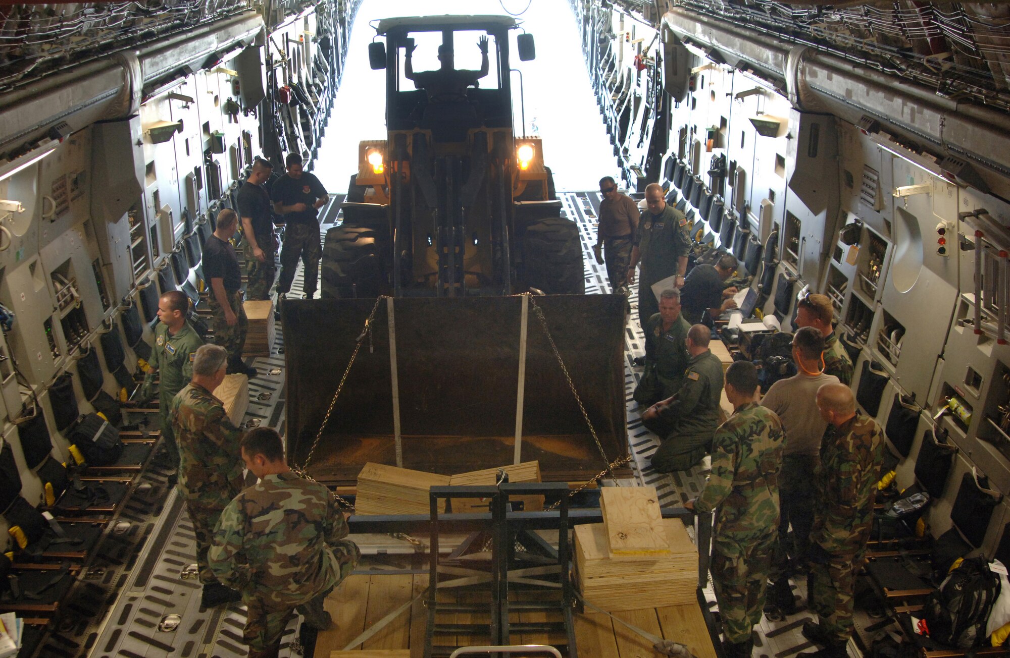 Airmen from the 300th Airlift Squadron at Charleston Air Force Base, S.C., and the 433rd Civil Engineer Squadron at Lackland AFB, Texas, load cargo at a Saint Lucia airport for a return flight on Sunday, April 9, 2006. The aircrew delivered construction materials and Reserve civil engineers who are building an operations center and barracks for the police force in support of Saint Lucia's counter-drug operations.  (U.S. Air Force photo/Tech. Sgt. Larry A. Simmons)