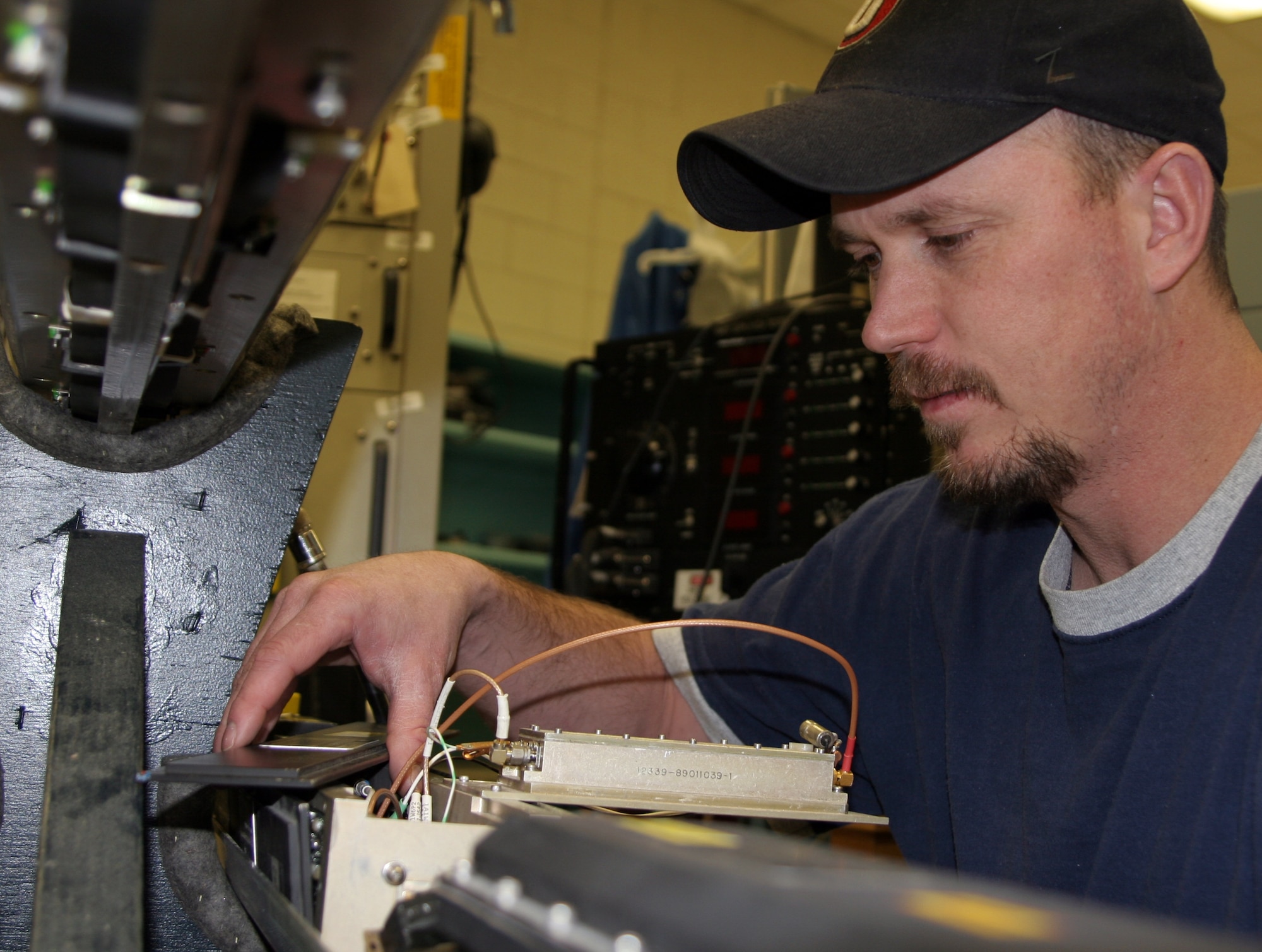 HILL AIR FORCE BASE, Utah  - Shane Wright, an integrated electronic equipment repairer for the 309th Electronic Maintenance Group here, assesses a P4B mockup pod for power amp testing.  (Air Force photo by G. A. Volb)  


