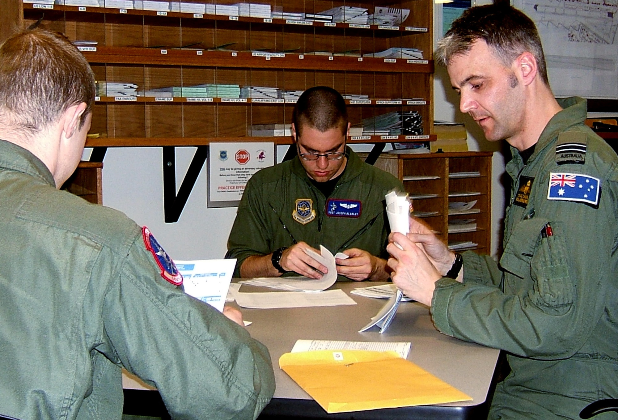 Flight Lieutenant Craig Chaseling, Royal Australian Air Force exchange pilot, debriefs his crew after returning from a refueling trip from Alaska. “He is always in the squadron working really hard trying to get everybody up-to-date on their training requirements,” said 1st Lieutenant Jocelyn Smith, the mission’s co-pilot. “He is very efficient at his job, and it’s obvious why he has been selected as the instructor pilot of the quarter.” (U.S. Air Force photo by Shadi May.)