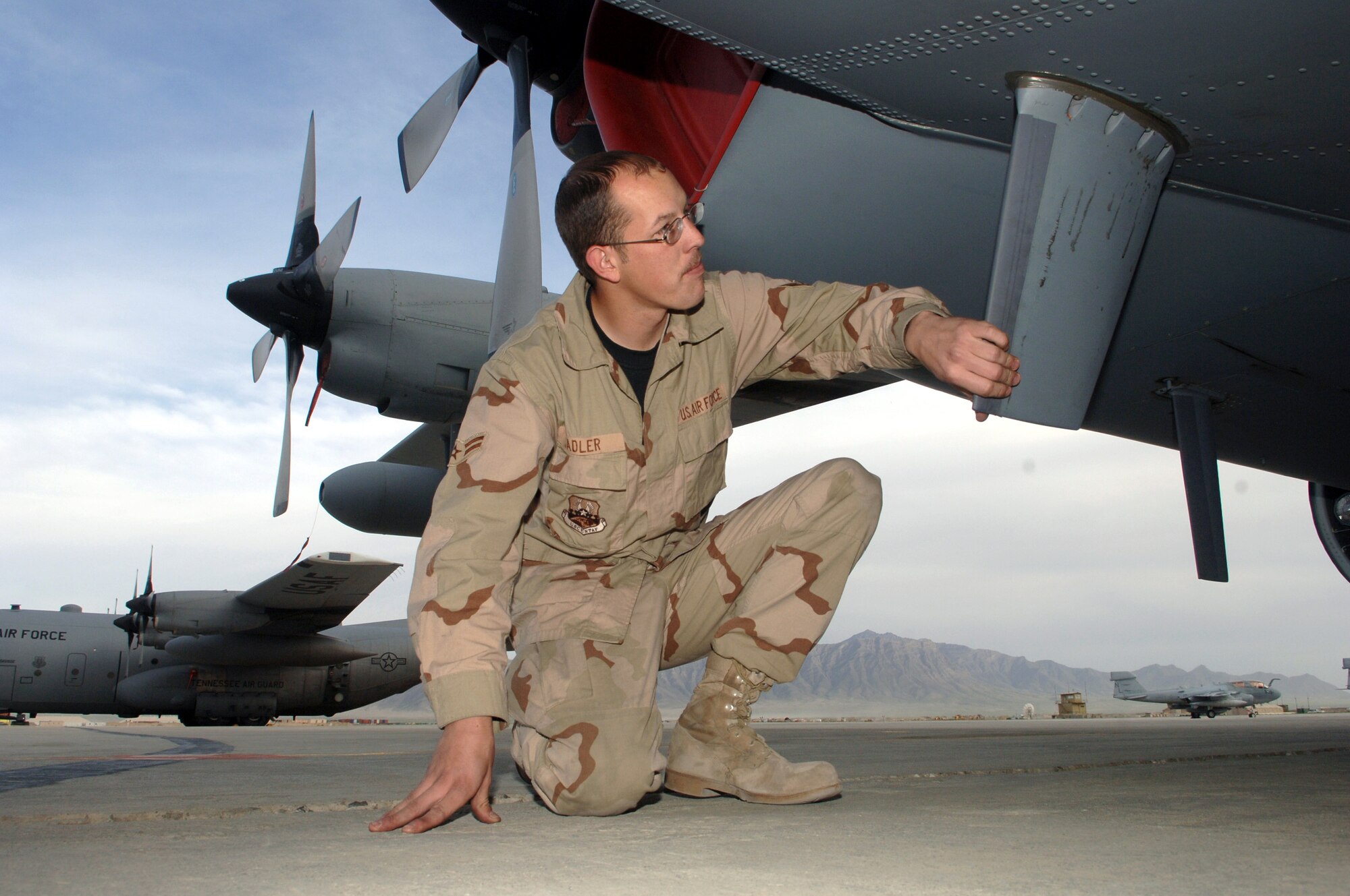 Airman 1st Class Weston Sadler inspects an antenna on an EC-130H Compass Call from the 41st Expeditionary Electronic Control Squadron at Bagram Air Base, Afghanistan, on Thursday, April 13, 2006.  The Compass Call is an airborne tactical weapon system used to deny, degrade and disrupt the enemy's ability to communicate. Since April 2004, 41st EECS EC-130s have flown more than 700 combat sorties supporting ground forces in Operation Enduring Freedom.  Airman Sadler is a crew chief with the 41st and is deployed from Davis-Monthan Air Force Base, Ariz. (U.S. Air Force photo/Staff Sgt. Jennifer Redente) 

