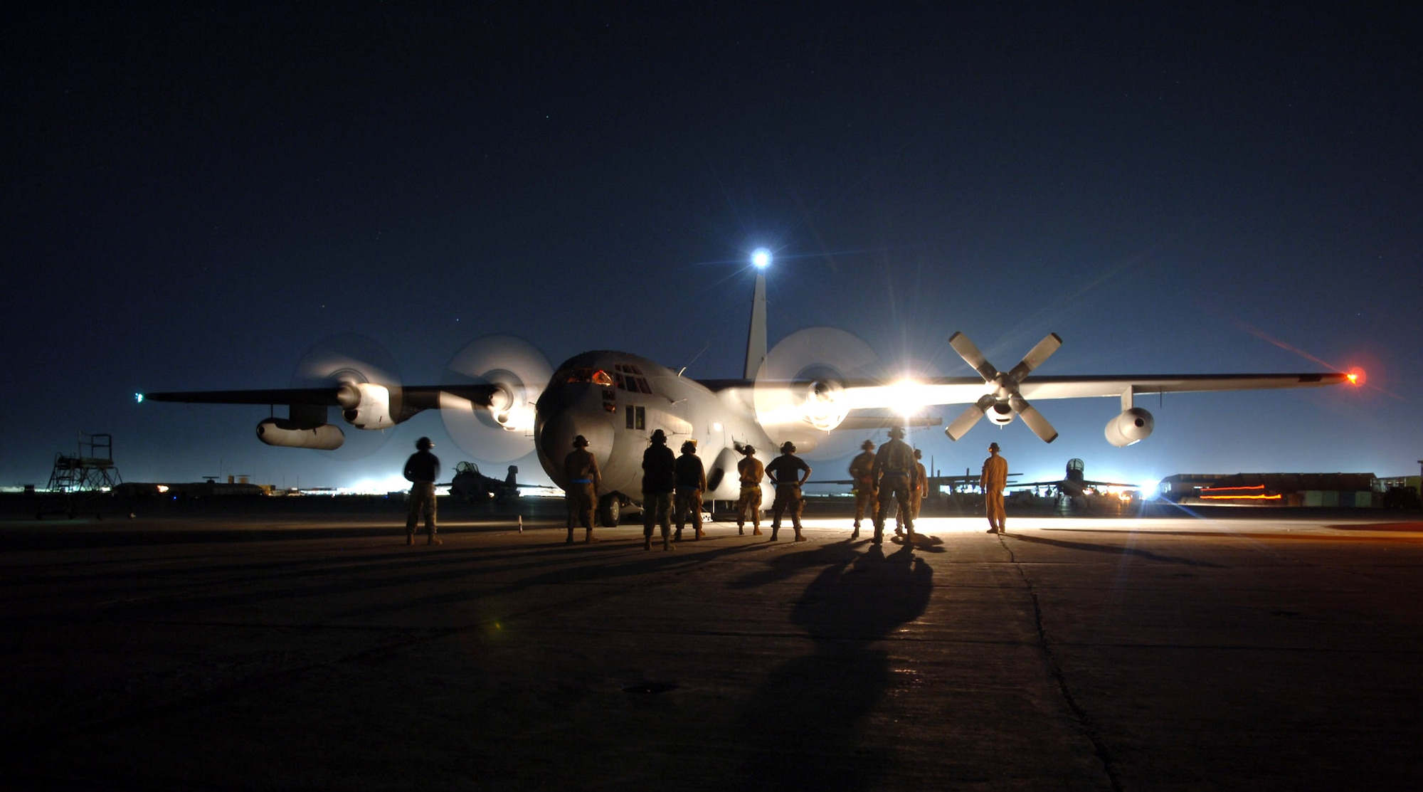 Maintainers at Bagram Air Base, Afghanistan, stand by as the aircrew starts the engines on an EC-130H Compass Call's. The aircraft is assigned to the 41st Expeditionary Electronic Combat Squadron. The Compass Call is an airborne tactical weapon system used to deny, degrade and disrupt the enemy's ability to communicate.  Since April 2004, 41st EECS EC-130s have flown more than 700 combat sorties supporting ground forces in Operation Enduring Freedom.  (U.S. Air Force photo/Capt. James H. Cunningham)
