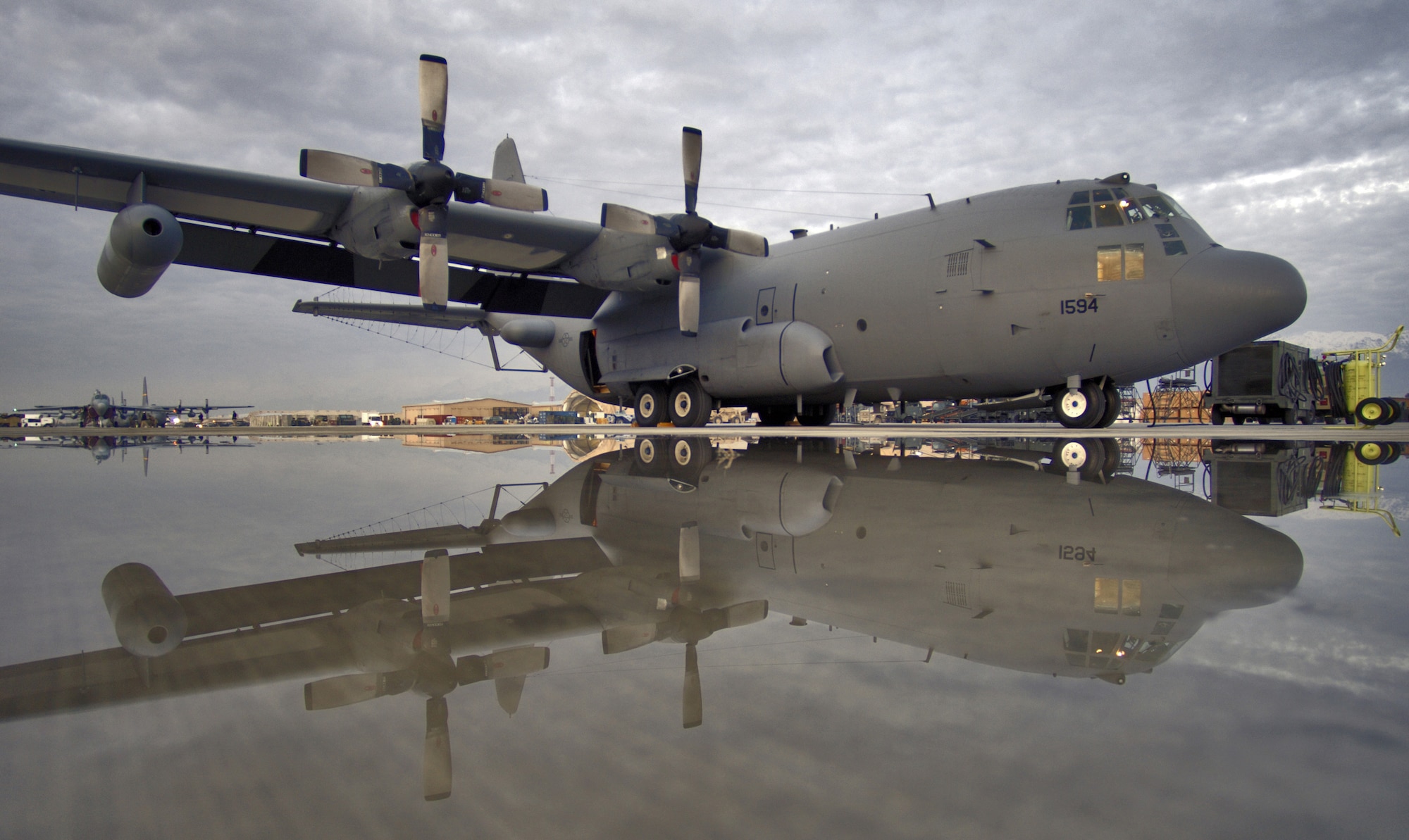 An EC-130H Compass Call from the 41st Expeditionary Electronic Control Squadron sits on the flightline at Bagram Air Base, Afghanistan, as its crew prepares for a night mission. The Compass Call is an airborne tactical weapon system used to deny, degrade and disrupt the enemy's ability to communicate.  Since April 2004, 41st EECS EC-130s have flown more than 700 combat sorties supporting ground forces in Operation Enduring Freedom. (U.S. Air Force photo/Master Sgt. Lance Cheung) 