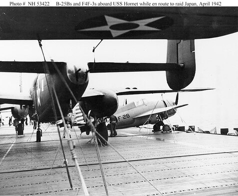 U.S. Army Air Forces B-25B bombers and Navy F4F-3 fighters tied down on the flight deck of USS Hornet (CV-8) before the start of the operation. Note wooden dummy machine guns in the tail cone of the B-25 at left. (U.S. Navy photo)