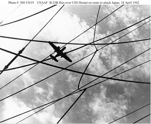 A U.S. Army Air Forces B-25B bomber flies over USS Hornet (CV-8) while on its way to attack targets in Japan, just after it was launched on the morning of April 18, 1942. (U.S. Navy photo)