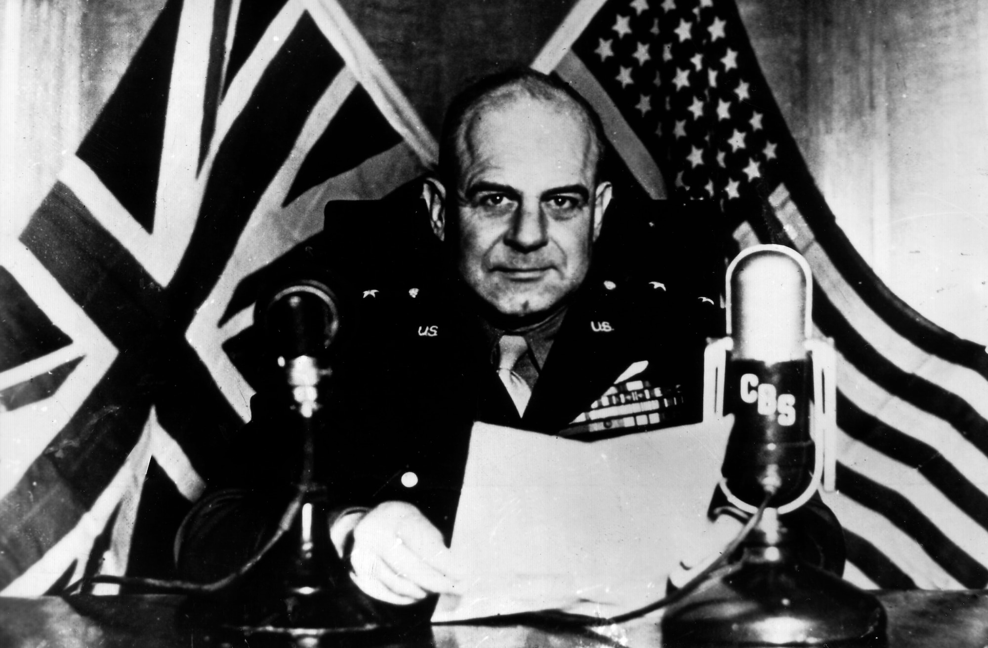 Lt. Gen. James H. Doolittle, commander of Army Air Forces Eighth Air Force, speaks on a British radio program observing the launch of the U.S. aircraft carrier USS Shangri-La. General Doolittle reported that the 8th AF knocked out more than 1,500 German fighter planes and dropped more than 24,000 tons of bombs on Germany in April, 1944. (U.S. Air Force photo)