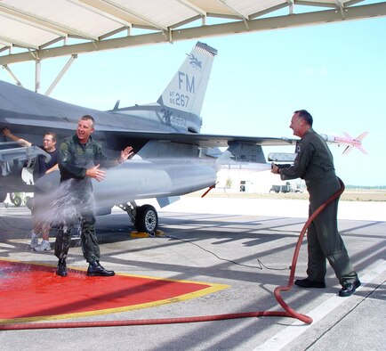 Lt.Col. Tracy Hunt soaks outgoing 482nd Fighter Wing Vice Commander Col. David Lint after his final flight here at Homestead Air Reserve Base, Fla. on April 7. Col. Lint leaves Homestead after nearly 15 years flying with the 93rd Fighter Squadron Makos.  He is now assigned to Reserve Affairs at the Pentagon under the directorate of Air Force Reserve Commander Lt. Gen. John Bradley. (Air Force Reserve photo by Lisa Macias) 