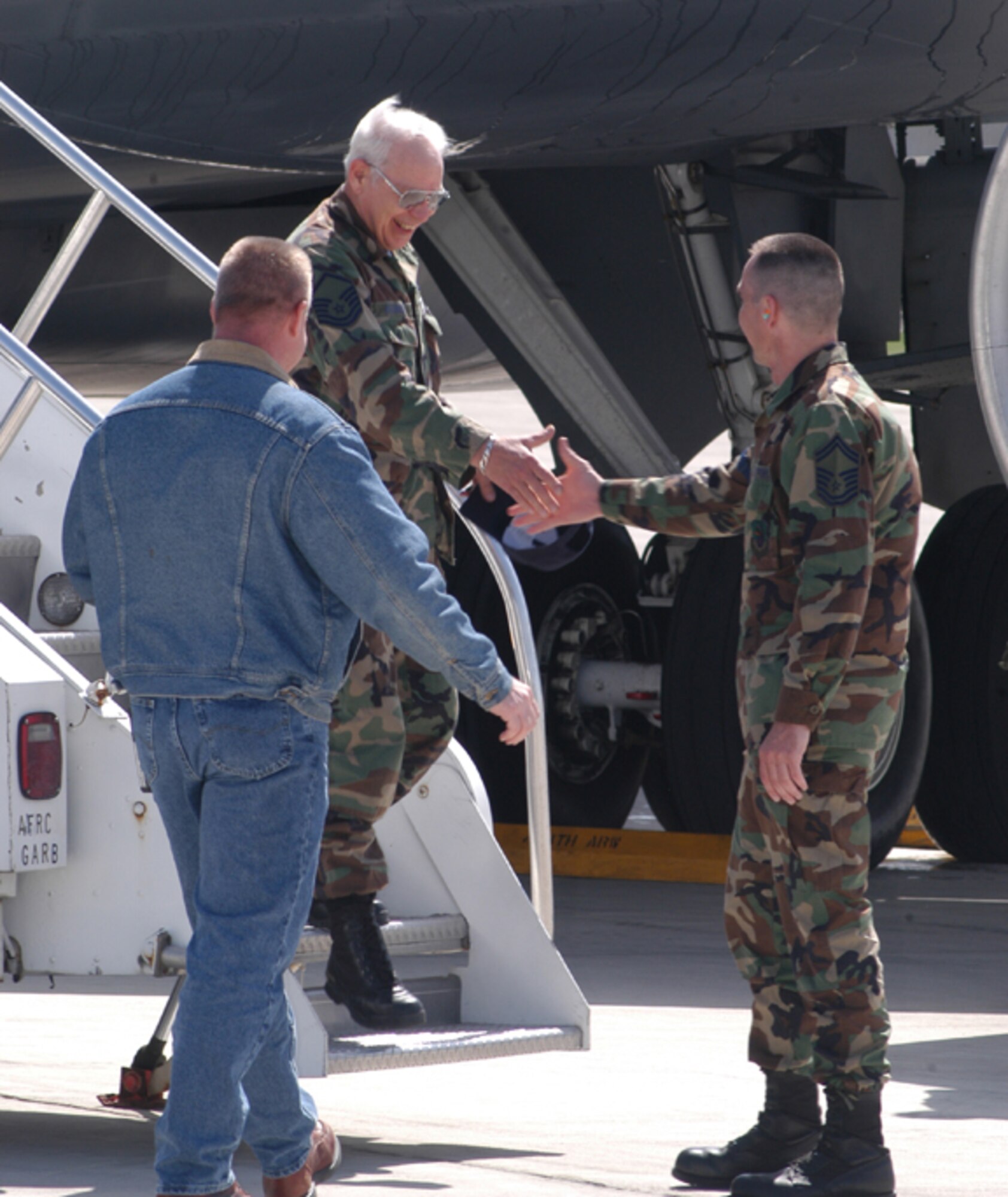 GRISSOM AIR RESERVE BASE, Ind. -- Master Sgt. Roger Redmon, a crew chief with the 434th Aircraft Maintenance Squadron, is greeted by SMSgt. Charles Hoover, right, and Master Sgt. Tony Hoffman, left, both 434th AMXS members, as he returns from a recent TDY. The flight was Sergeant Redmon's last in a 40-year career as a crew chief. (Photo by SrA. Roberto Modelo)
