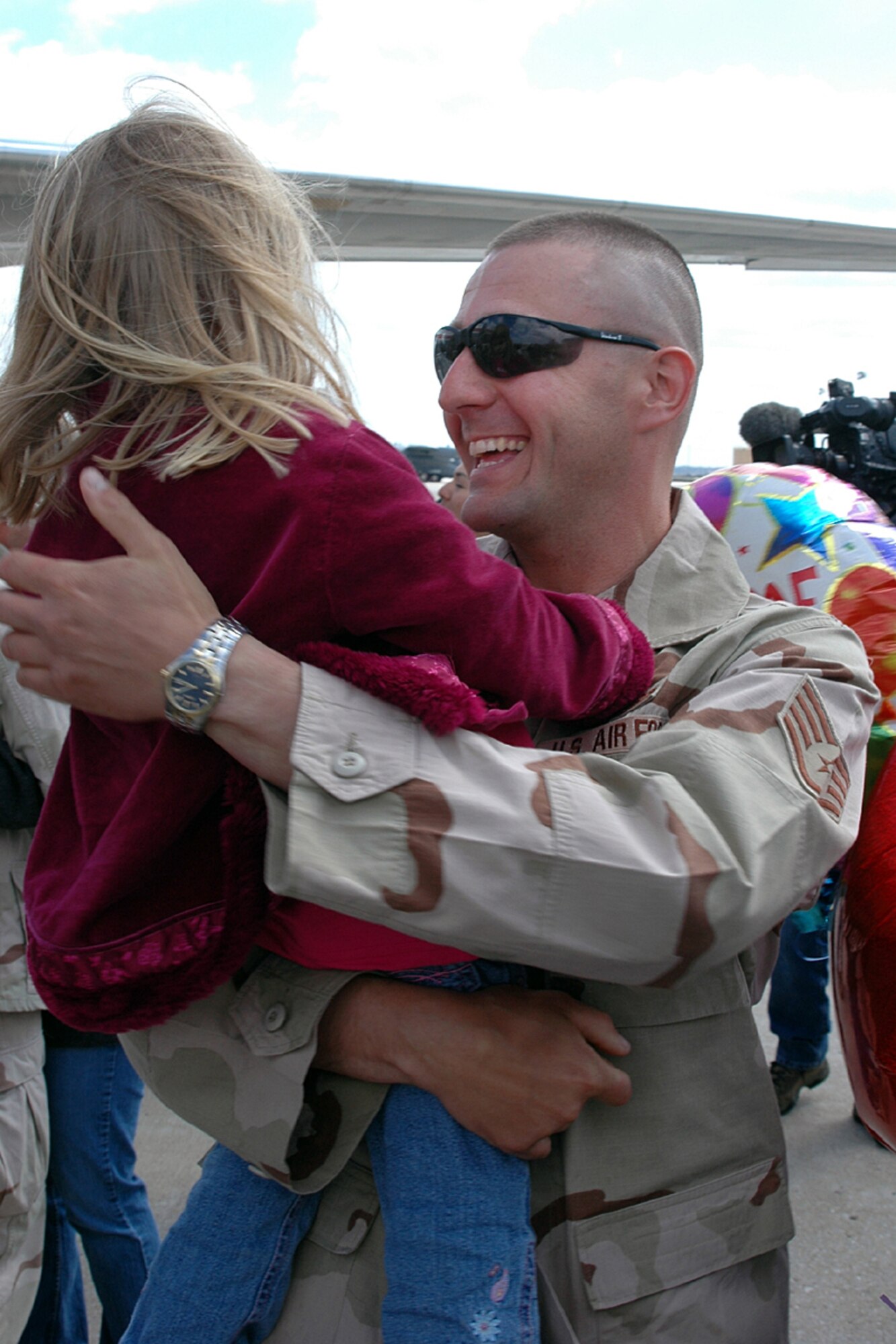 SSgt Darryl Gulleckson, 375th SFS, reunites with  daughter Krysta  following an eight month deployment to Iraq.