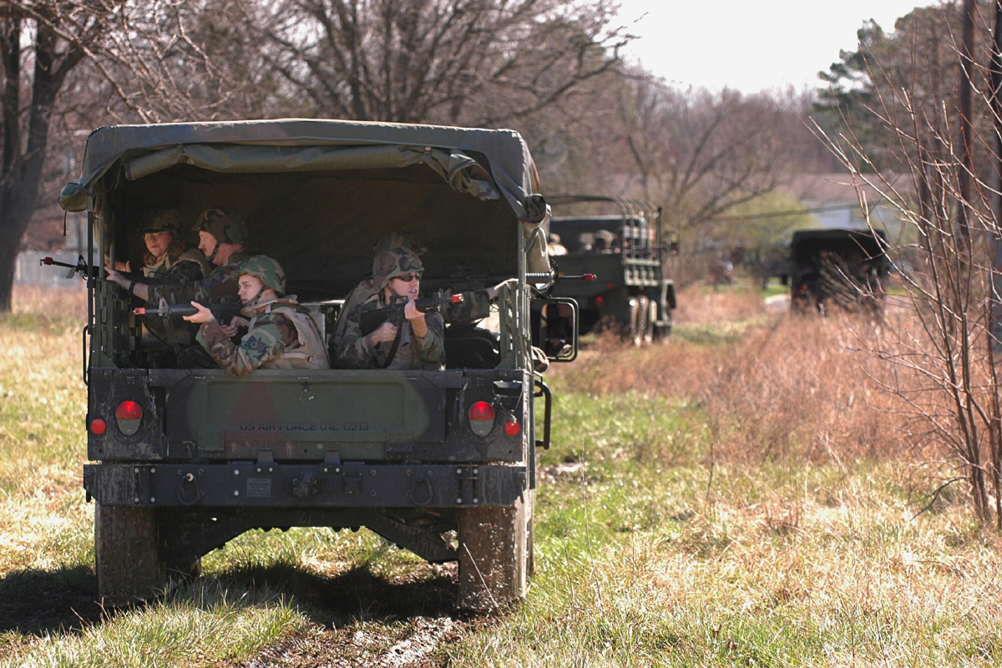 Scott AFB Expeditionary Combat Skills trainees search for aggressors during the mock convoy portion of the training.