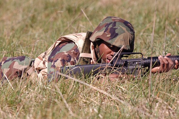 A Scott Expeditionary Combat Skills trainee provides cover for his comrades during the mock convoy portion of the training.