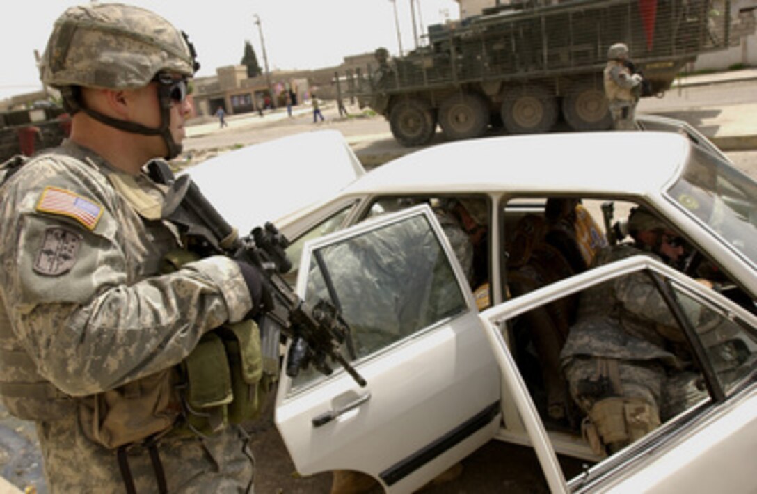 U.S. Army soldiers search a vehicle during a neighborhood patrol in Mosul, Iraq, on April 15, 2006. The soldiers are with the 1st Battalion, 17th Infantry Regiment, 172nd Infantry Brigade Combat Team. 