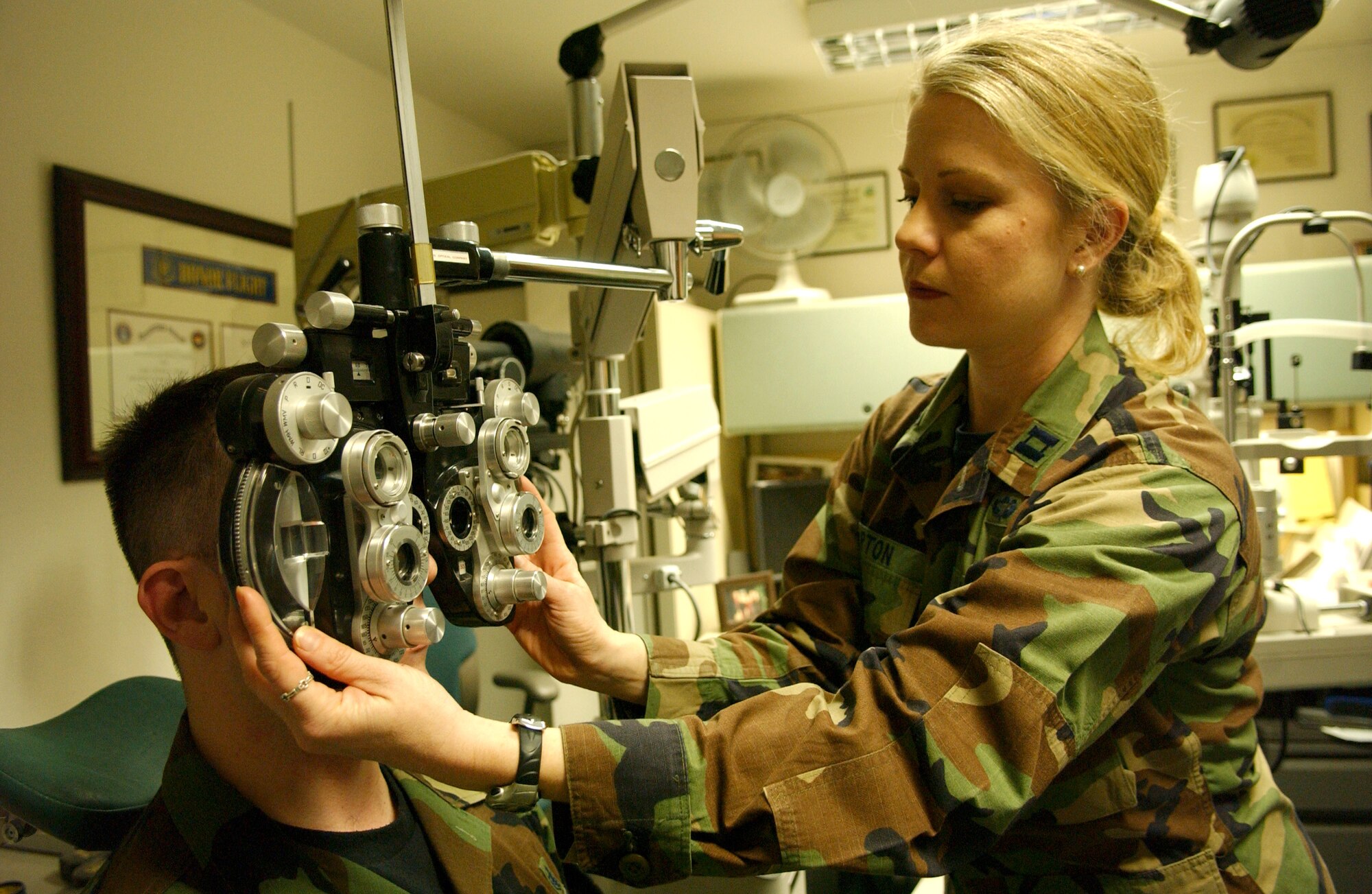 Capt. Christie Barton determines a prescription for Staff Sgt. Kevin Keene. Captain Barton is an optometrist with the 435th Aerospace Medicine Squadron at Ramstein Air Base, Germany. Sergeant Keene is with the 435th Dental Squadron. (U.S. Air Force photo/Airman Julianne Trulson)
