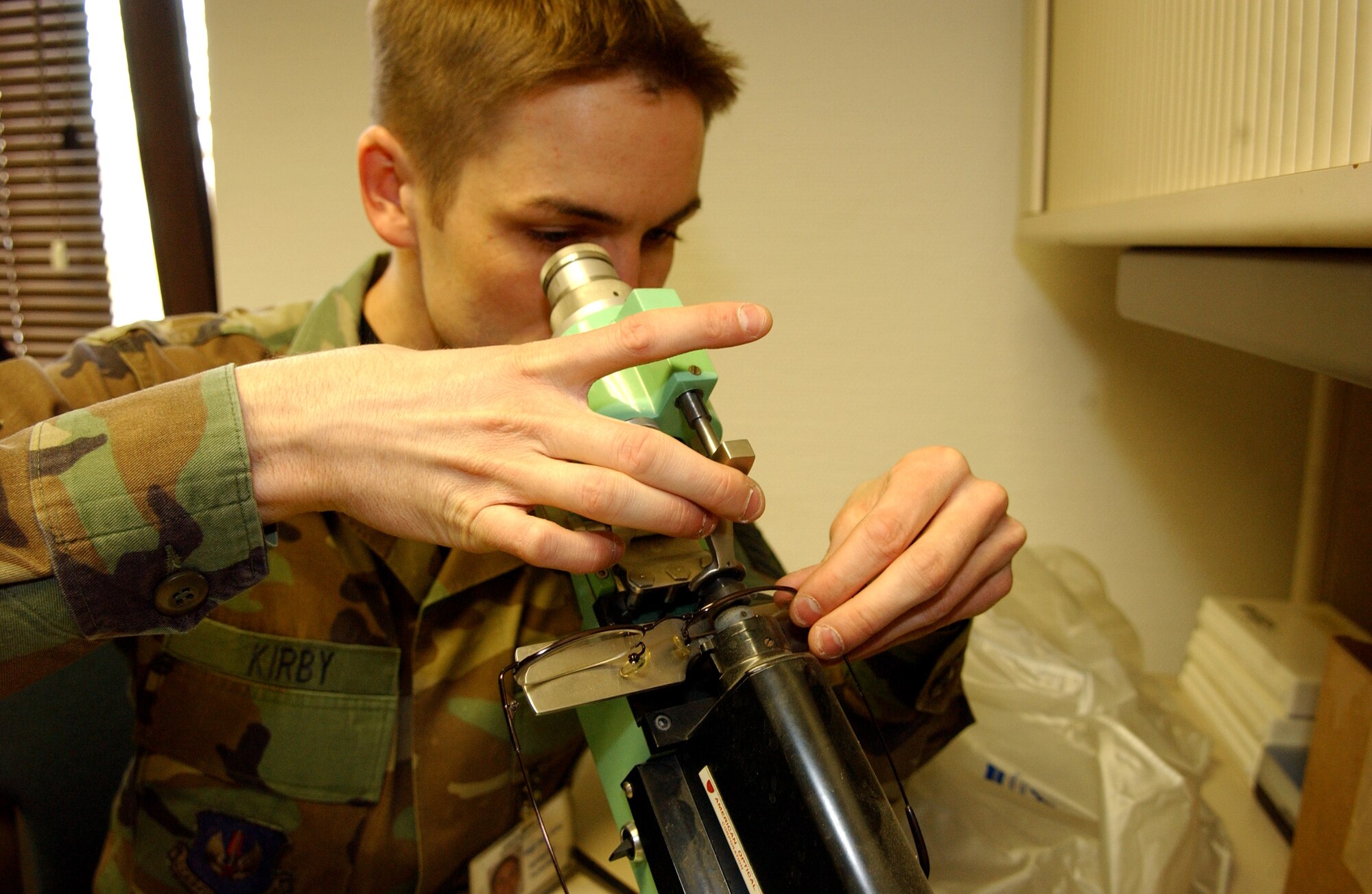 Staff Sgt. Allen Kirby checks a pair of glasses for lens prisms with a microscope. He is an optometry technician assigned to the 435th Aerospace Medicine Squadron at Ramstein Air Base, Germany. (U.S. Air Force photo/Airman Julianne Trulson)
