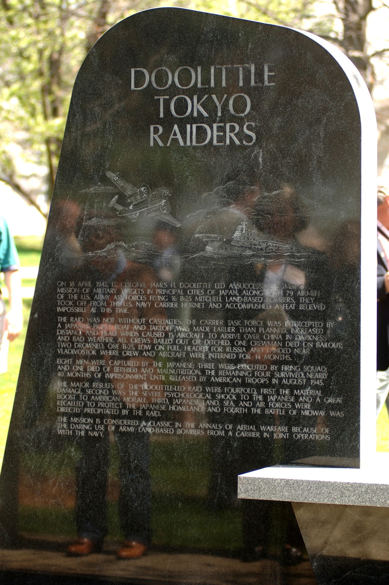 Friends and family of the Doolittle Raiders are reflected on a memorial marble tablet dedicated to the 80 men who flew with Lt. Col. James H. Doolittle on the successful Tokyo Raid of April 18, 1942. The Doolittle Raiders celebrated their 64th reunion in Dayton, Ohio, on Tuesday, April 18, 2006. (U.S. Air Force photo/Tech. Sgt. Cecilio M. Ricardo Jr.)