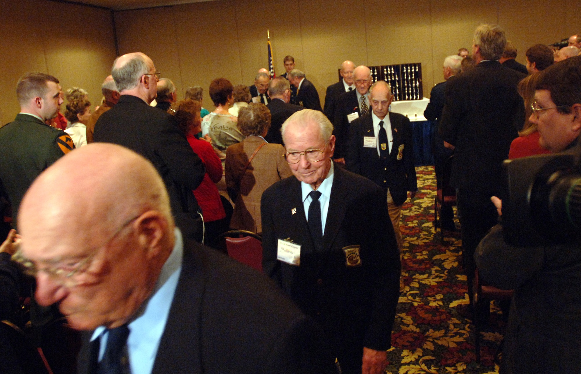 Retired Lt. Col. Frank Kappeler (center) and seven other of the 16 remaining Doolittle Raiders adjourn from their 64th reunion goblet ceremony with a standing ovation from friends, family and media in Dayton, Ohio, on Tuesday, April 18, 2006. The solemn goblet ceremony honors the Doolittle Raiders and the accomplishments of their April 18, 1942, Tokyo Raid. (U.S. Air Force photo/Tech. Sgt. Cecilio M. Ricardo Jr.)