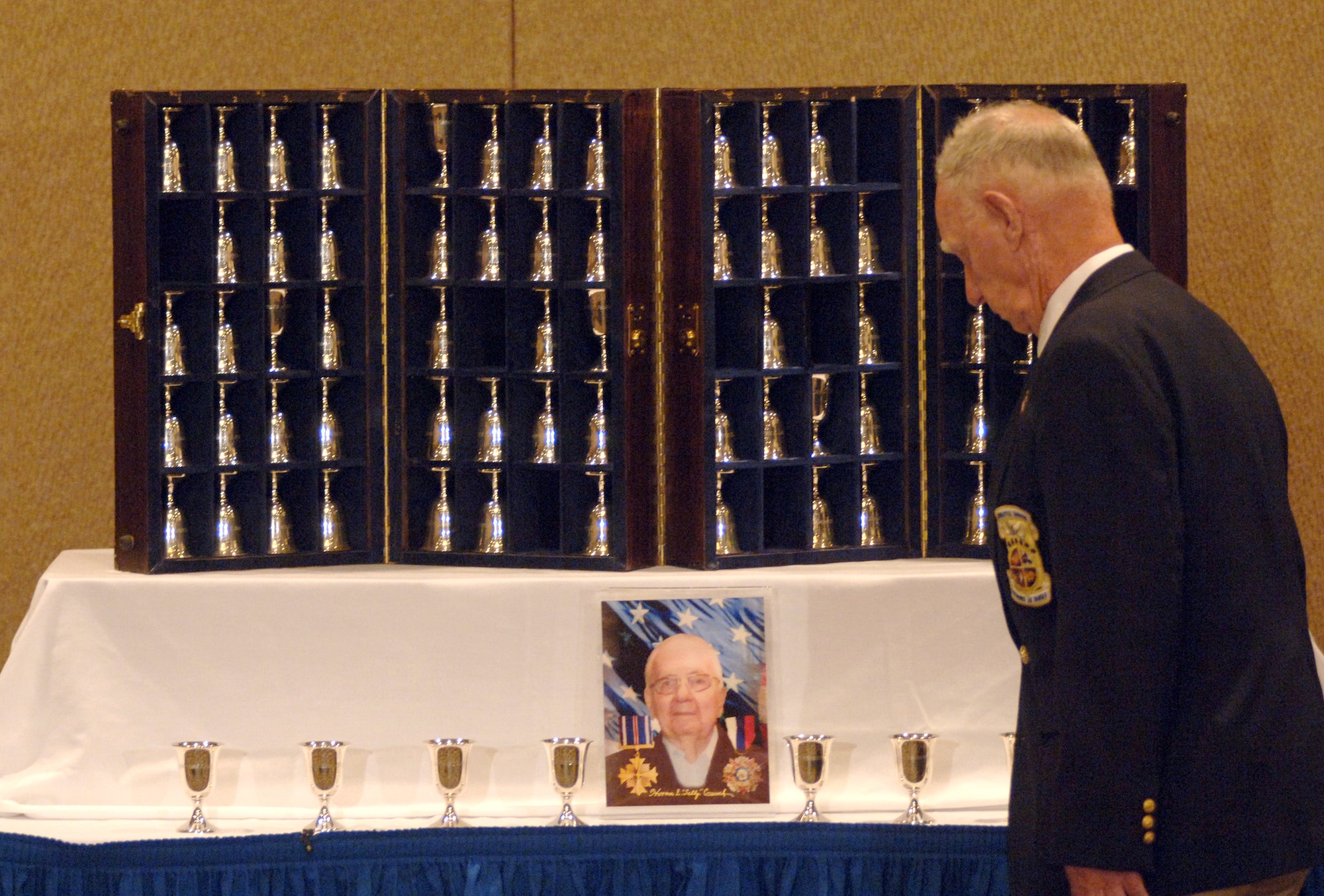 Retired Master Sgt. Ed Horton honors the memory of retired Lt. Col. Horrace Crouch by turning his goblet upside down at the goblet ceremony during the 64th Doolittle Raider reunion in Dayton, Ohio, on Tuesday, April 18, 2006. The goblet ceremony is held to honor the Raiders who died since their last meeting. This year, they honored Colonel Crouch, who passed away Dec. 21 from pneumonia. (U.S. Air Force photo/Tech. Sgt. Cecilio M. Ricardo Jr.)