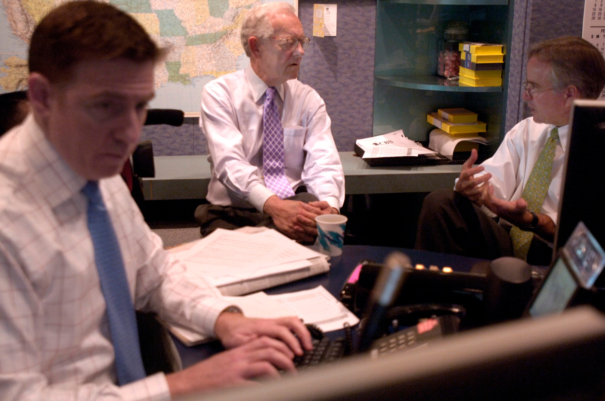 Bob Schieffer, chief Washington correspondent for "CBS News" and anchor/moderator of "Face the Nation," discusses the news lineup with Rome Hartman (right), executive producer, and Bill Owens, senior broadcast producer, at CBS in New York City on Tuesday, April 11, 2006. Mr. Schieffer once served in the Air Force as editor of The Global Ranger newspaper at Travis Air Force Base, Calif. (U.S. Air Force photo/Master Sgt. Scott Wagers) 