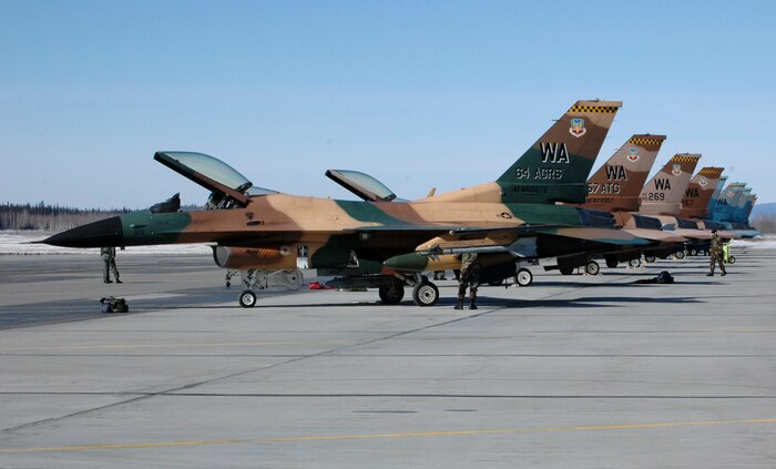 F-16 Fighting Falcons from the 64th Aggressor Squadron at Nellis Air Force Base, Nev., line the flightline at Eielson AFB, Alaska, on Tuesday, April 18, 2006, for Red Flag - Alaska.  The exercise, formerly known as Cope Thunder, provides joint offensive counter-air, interdiction, close-air support and large-force employment training in a simulated combat environment. Red Flag - Alaska runs through May 5. (U.S. Air Force photo/Airman 1st Class Justin Weaver)