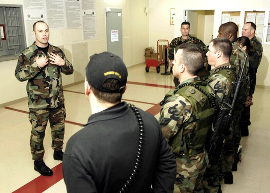 Senior Master Sgt. Timothy Cook, 92nd Security Forces Squadron operations superintendent, talks with Security Forces Airmen before they get their orders for the day. The 92nd Security Forces Squadron as a whole have been awarded the title of best in AMC and will now compete at the Air Force level for that title. Sergeant Cook is a finalist in the AMC 12 Outstanding Airmen of the Year contest. (U.S. Air Force Photo by Senior Airman Anthony Ennamorato.)