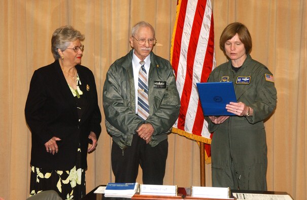 Col. Lyn Sherlock, 60th AMW commander, reads an award citation before presenting  Mr. Robert Andrews, 60th Comptroller Squadron, with a pin honoring his 50 years of federal service. (U.S. Air Force photo by Nan Wylie)