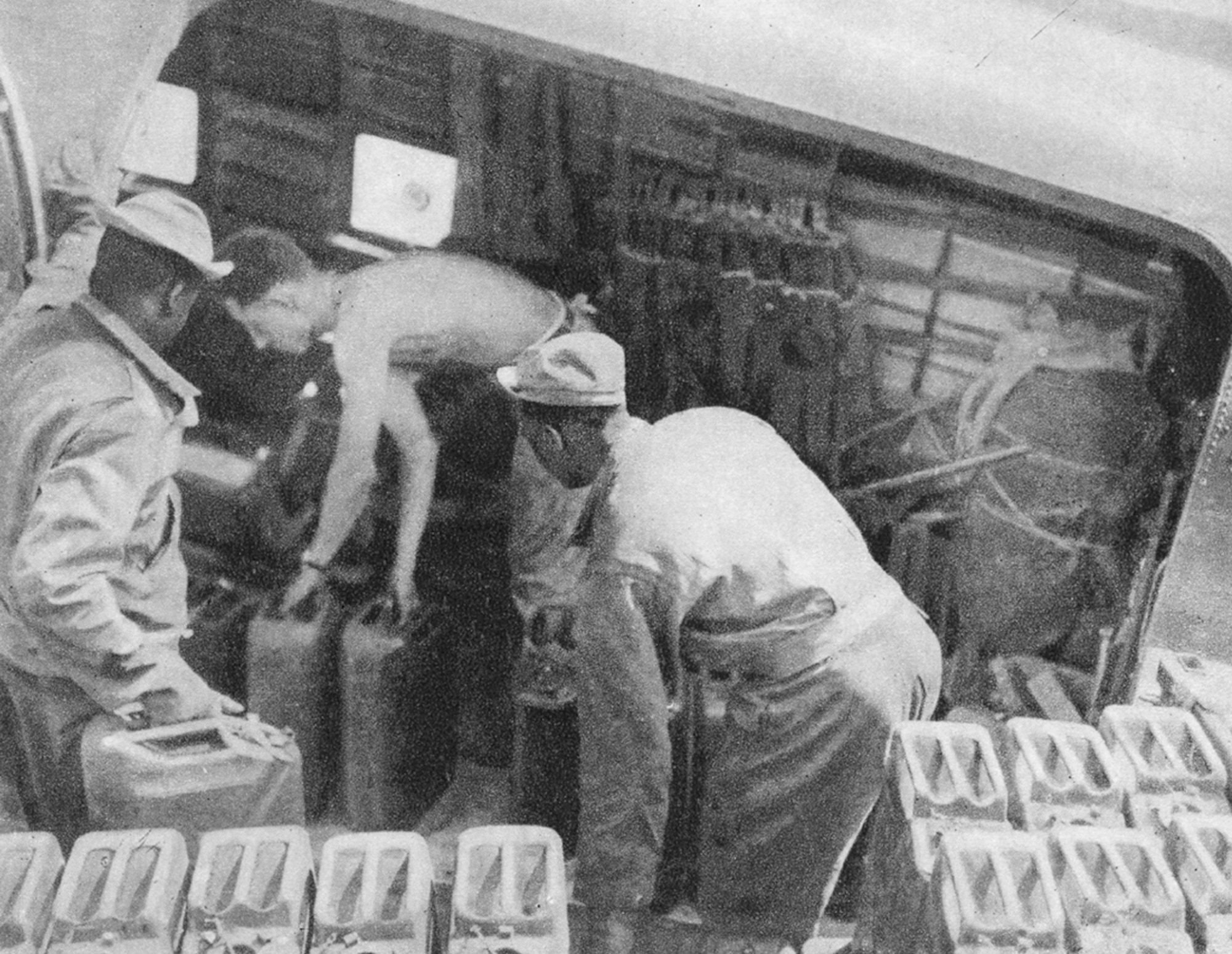 Five-gallon "jerry" cans containing gasoline or diesel fuel were regular cargo items on 442nd Troop Carrier Group aircraft after World War II.
