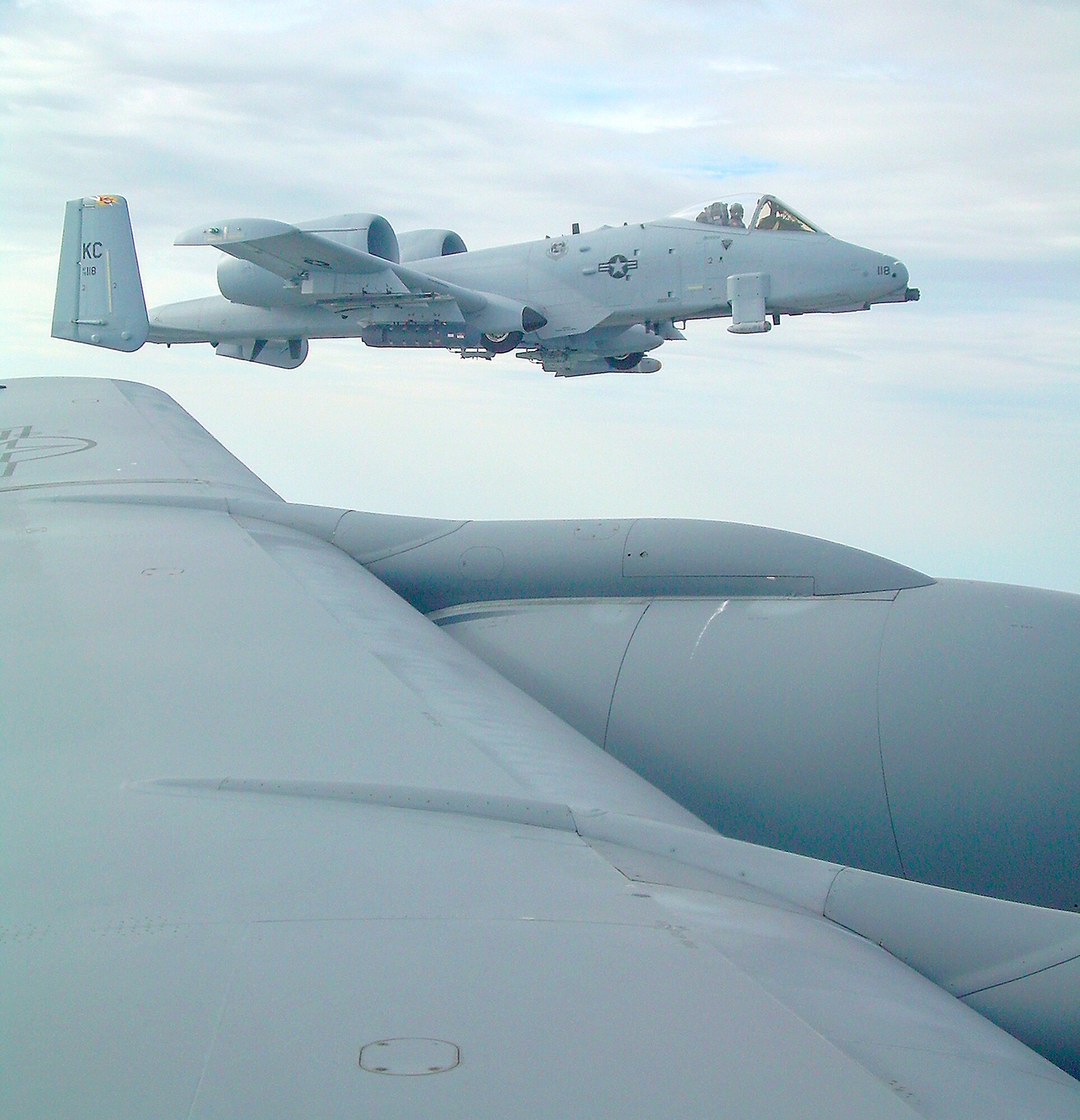 An A-10 Thunderbolt II from the Air Force Reserve's 303rd Fighter Squadron, flown by Maj. Les Bradfield, flies formation off the left wing of a KC-135 Stratotanker as part of the 442nd Fighter Wing's and 509th Bomb Wing's combined civic leader tour April 11. Business and government leaders from around Missouri attended the tour, which fetured stops at Edwards Air Force Base, Calif., and McChord AFB, Wash.  (Photo by Maj. David Kurle)