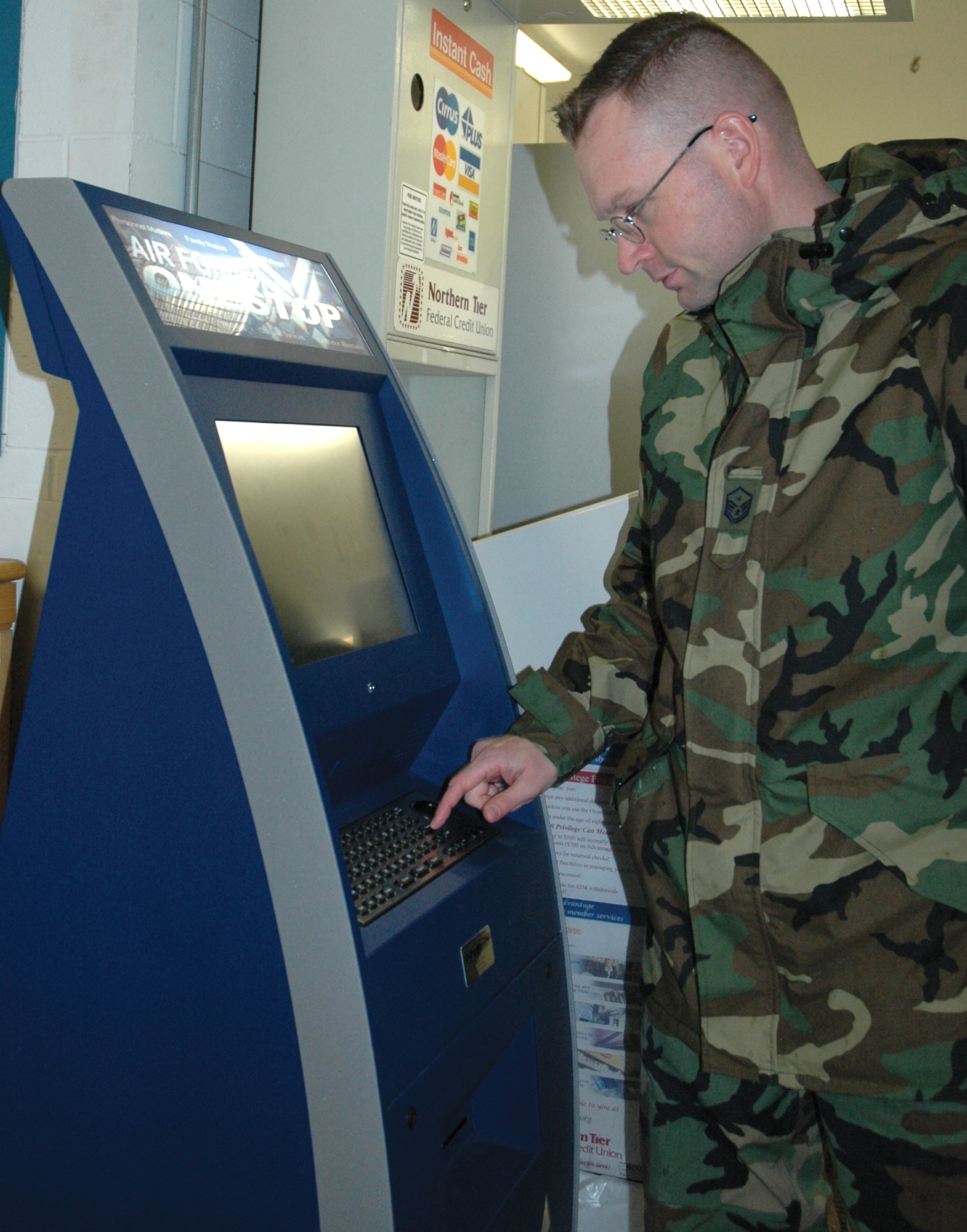 Master Sgt. Christopher Kozel, 91st Operations Group, uses the Air Force OneStop kiosk located inside the Shoppette for the first time Tuesday. (U.S. Air Force photo by Senior Airman Danny Monahan)