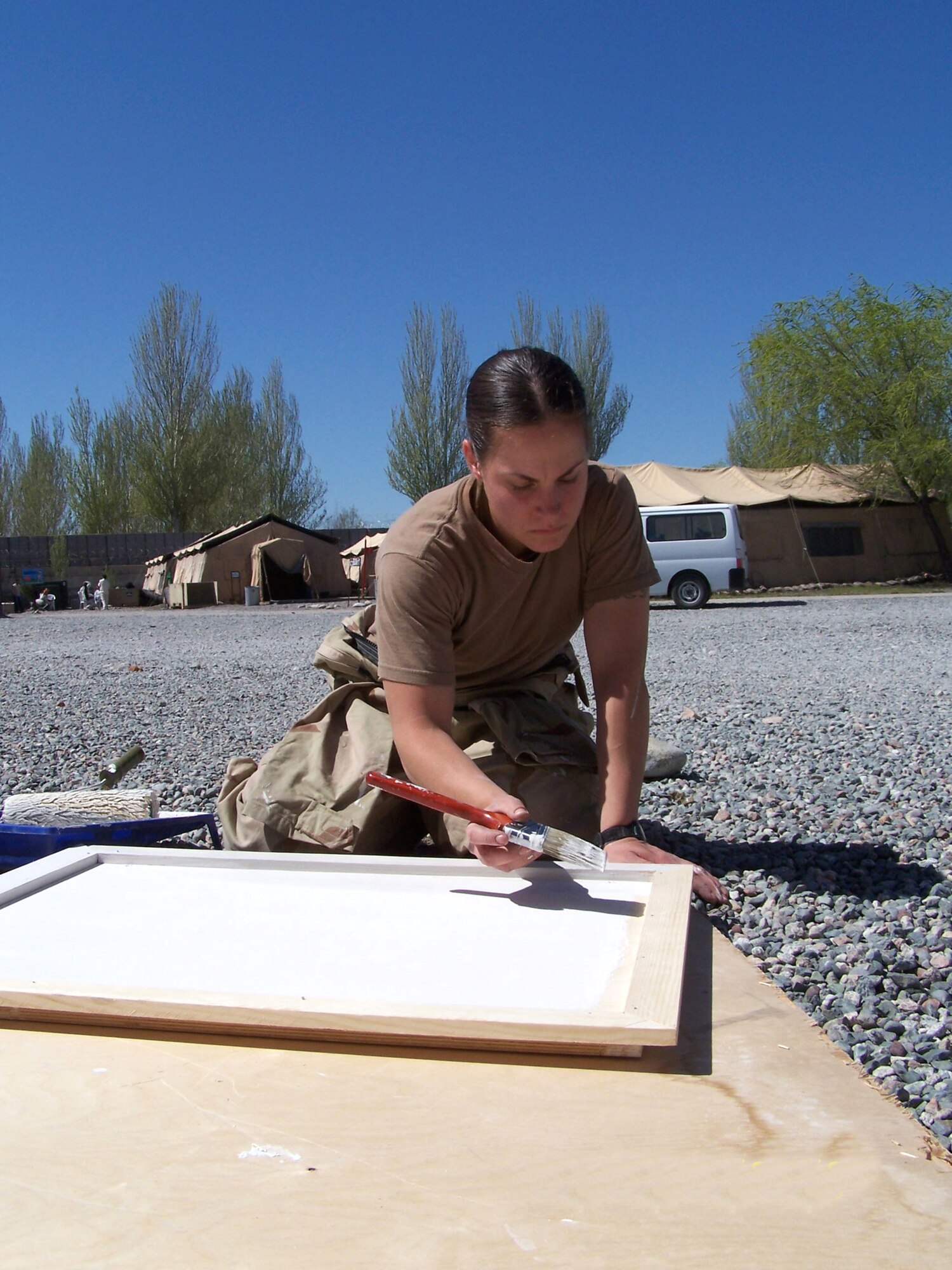 Senior Airman Tina McIlmoyle paints a cover for an access door at the newly renovated wing headquarters at Manas Air Base, Kyrgyzstan. (U.S. Air Force photo/Master Sgt. Roger Williams) 
