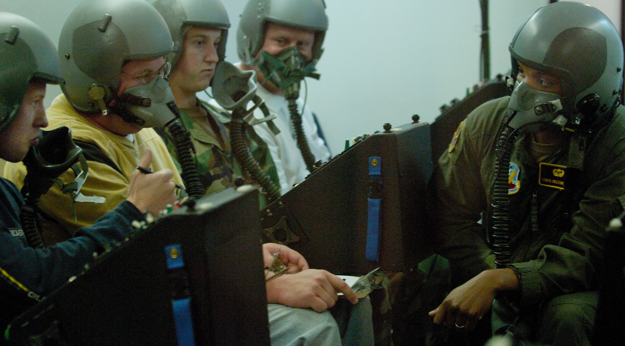 Senior Airman Christopher Helton , an aerospace physiology technicians stationed at Langley AFB, checks to see if one of the Federal Aviation Administration students is showing signs of hypoxia during an altitude chamber exercise on 19 Apr 2006 at the Aerospace Physiology facility on Langley. While in the altitude chamber students are exposed to atmospheric conditions at 25,000 ft. Without the aid of an oxygen mask they experience symptoms of hypoxia, a oxygen deficiency of the tissue and blood cells that causes impairment of function at high altitudes. (USAF Photo  By SSgt Samuel Rogers)