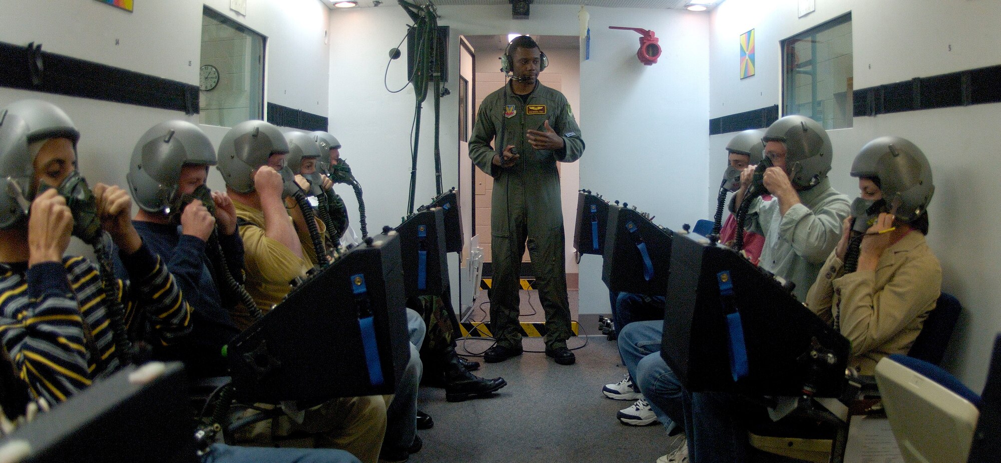 Tech Sgt. Rodney Morris (center), an aerospace physiology technician stationed at Langley AFB,goes over safety procedures in the altitude chamber with Federal Aviation Administration students, on 19 Apr 2006 at the Aerospace Physiology facility on Langley. While in the altitude chamber students are exposed to atmospheric conditions at 25,000 ft. Without the aid of an oxygen mask they experience symptoms of hypoxia, a oxygen deficiency of the tissue and blood cells that causes impairment of function at high altitudes. (USAF Photo By SSgt Samuel Rogers)