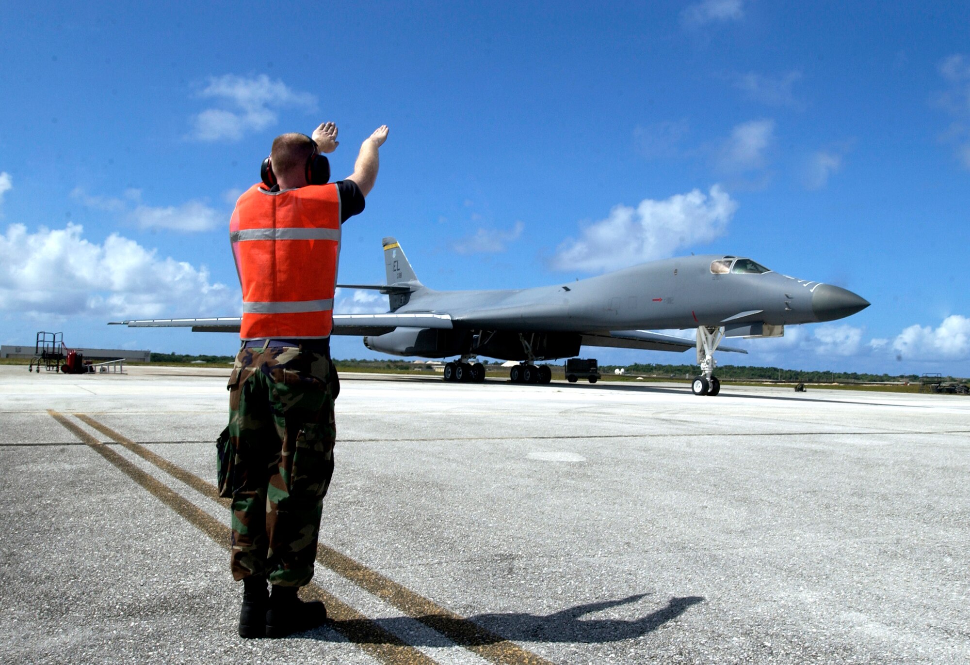 Senior Airman Patrick Bailey marshals a B-1B Lancer Monday, April 17, 2006, at Andersen Air Force Base, Guam. He is assigned to the 36th Expeditionary Aircraft Maintenance Squadron. (U.S. Air Force photo/Airman 1st Class Michael Dorus)
