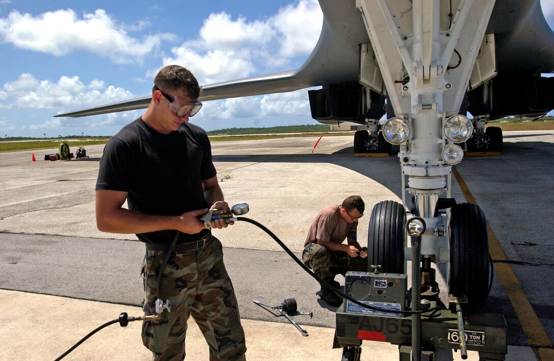 Senior Airman Alex Berger inflates a recently installed nose landing-gear tire on a B-1B Lancer while Senior Airman Thomas Feenstra prepares to replace the other one Monday, April 17, 2006, at Andersen Air Force Base, Guam. The Airmen are assigned to the 36th Expeditionary Aircraft Maintenance Squadron. (U.S. Air Force photo/Airman 1st Class Michael Dorus)
