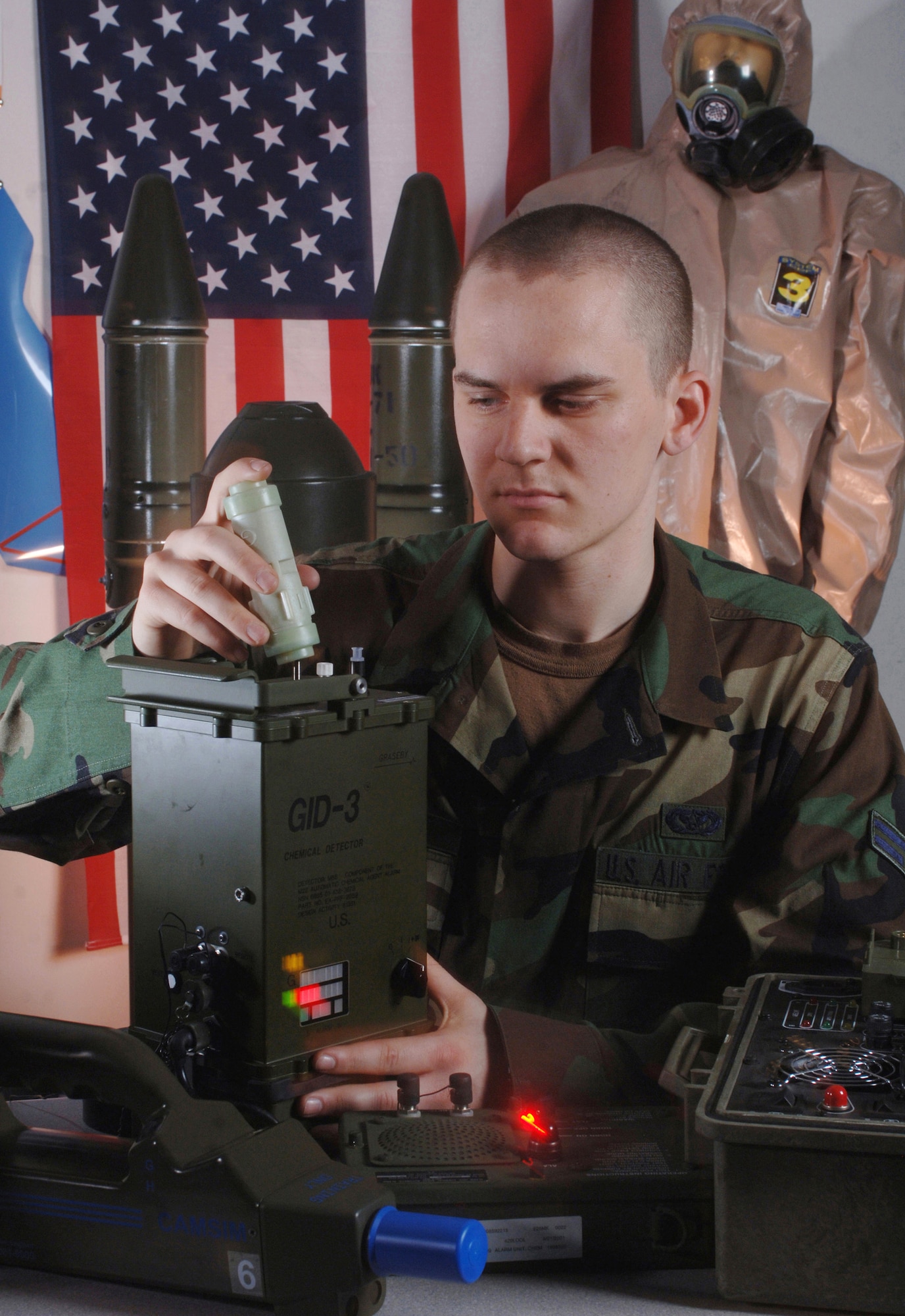 Airman 1st Class Jonathan Marion inspects an automatic chemical agent detector assembly, which is used to detect nerve and blister agents. Airman Marion is a readiness technician with the 374th Civil Engineer Squadron at Yokota Air Base, Japan. (U.S. Air Force photo/Val Gempis)