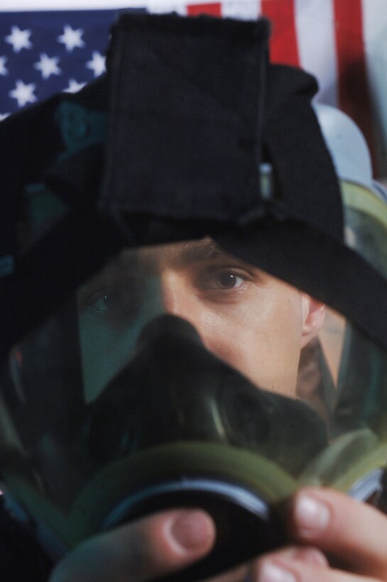 Staff Sgt. Brian Fagan checks a gas mask for leaks, cracks or holes, ensuring that it's serviceable. Sergeant Fagan is a readiness technician with the 374th Civil Engineer Squadron at Yokota Air Base, Japan. (U.S. Air Force photo/Val Gempis)
