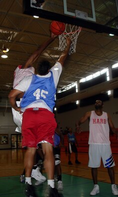 The offensive and defensive presence of Services center Anthony Brown was key to the outcome of the 2006 basketball intramural championship.  Brown scored 26 points in the championship and had several blocks on the defensive end of the court, like this one where he blocked an attempted lay-up by Nighthawks forward Dexter Porrata (Air Force Reserve photo by Jake Shaw).