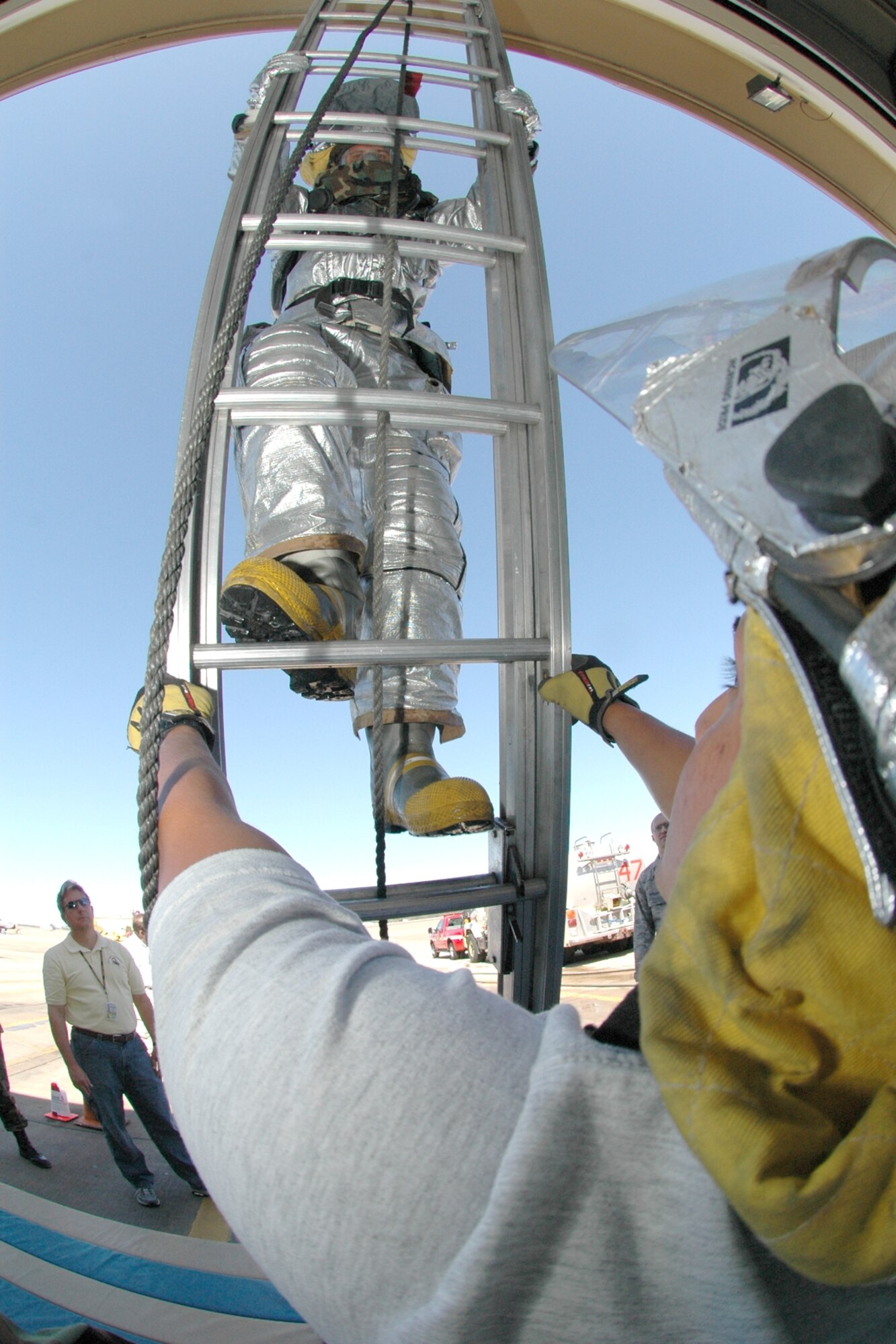 EGLIN AIR FORCE BASE, Fla. - Airman 1st Class Cody Ponder, 96th Civil Engineer Squadron firefighter, climbs a ladder as part of testing here for the Air Force's new fire uniforms. (Air force photo by Senior Airman Mike Meares)


