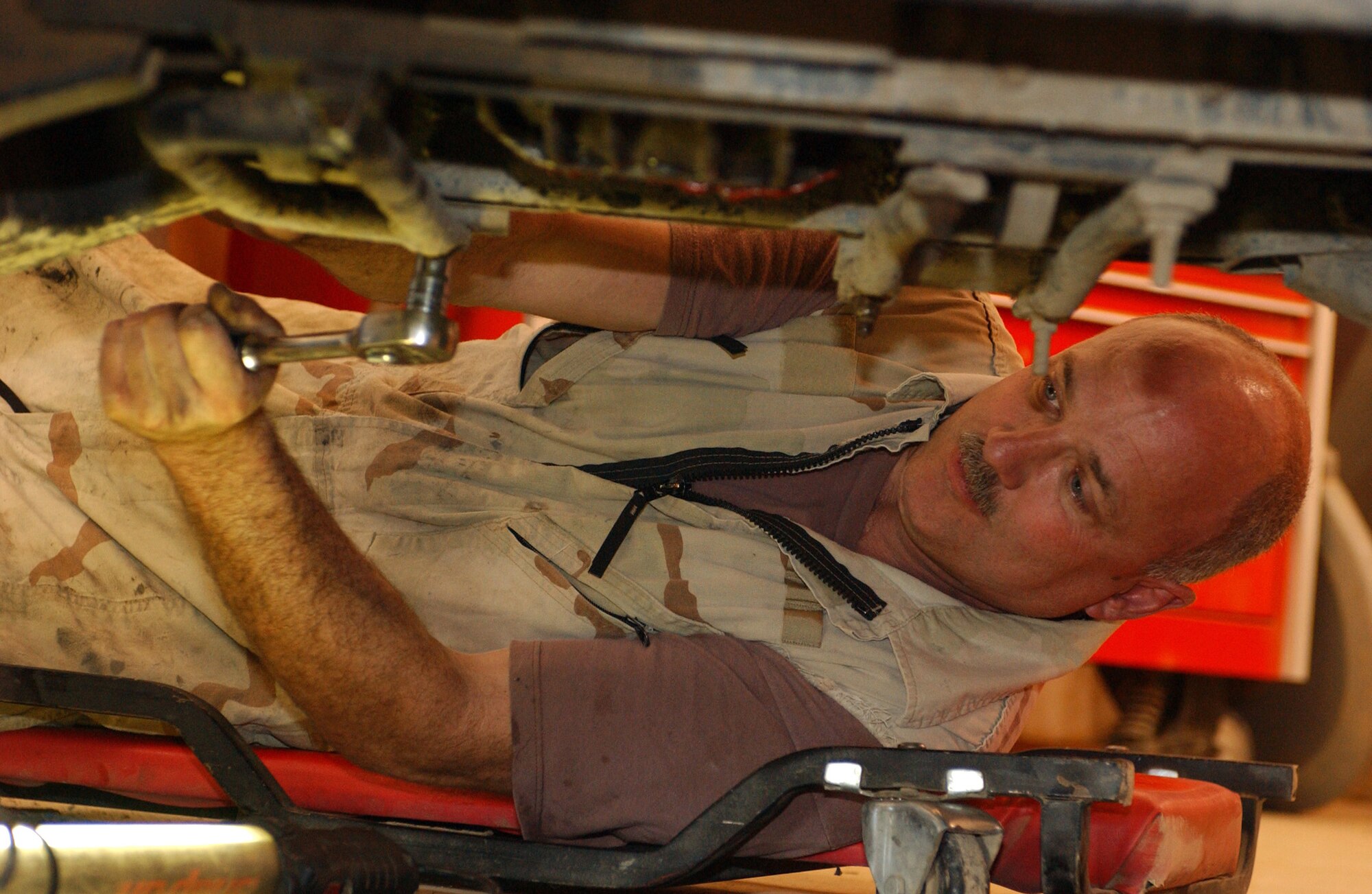 Staff Sgt. Rick Adams tightens a Humvee?s front brake support brackets at Ali Base, Iraq. Sergeant Adams is assigned to the 407th Expeditionary Logistics Readiness Squadron vehicle maintenance flight. He is deployed from the Pennsylvania Air National Guard's 171st Air Refueling Wing. (U.S. Air Force photo/Master Sgt. Jon Hanson)

