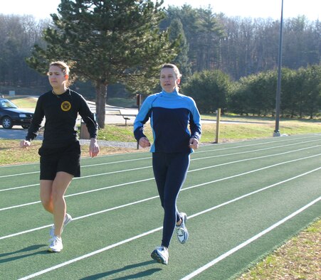 Second Lt. Ana Huffstetler (left) and Capt. Sabine Peters tune up their strides on the track at Hanscom Air Force Base, Mass., in preparation for the Boston Marathon April 17. Lieutenant Huffstetler is assigned to the 951st Electronic Systems Group and Captain Peters is assigned to the Electronic Systems Center. (Air Force photo/1st Lt. Martha Petersante-Gioia) 
