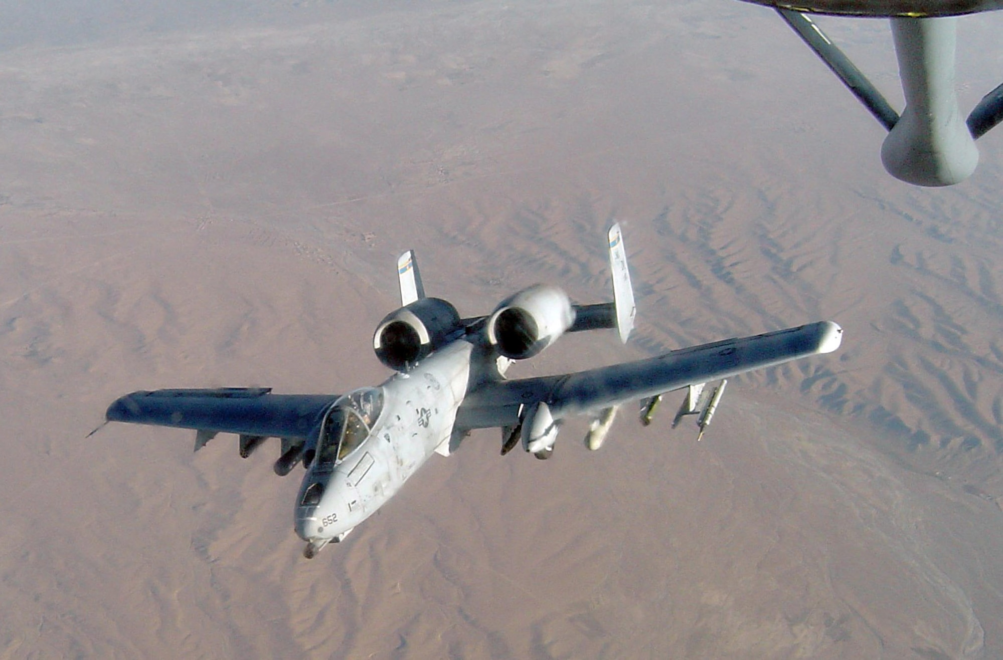 An A-10 Thunderbolt II carrying a Fighter Aircraft Communication Enhancement pod prepares to refuel in the skies over Bagram, Afghanistan. The pod enables ground units to relay their coordinates to patrolling aircraft, allowing them to engage the enemy as needed. (Courtesy Photo)