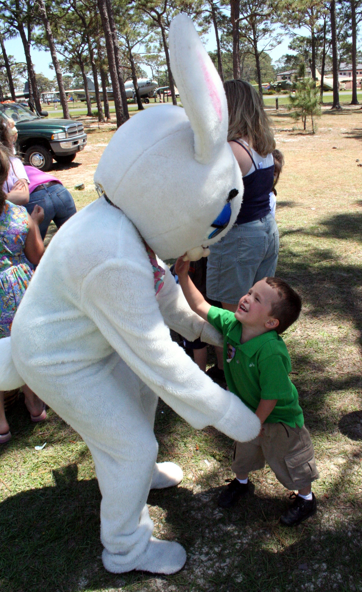 Dominique Colon, son of Staff Sgt. Rachel and Victor Colon, greets the Easter Bunny at the egg hunt and Family Fest Saturday morning in the community park. Airman 1st Class Megan Stanton, 16th Medical Support Squadron, spent the day inside the bunny suit. 