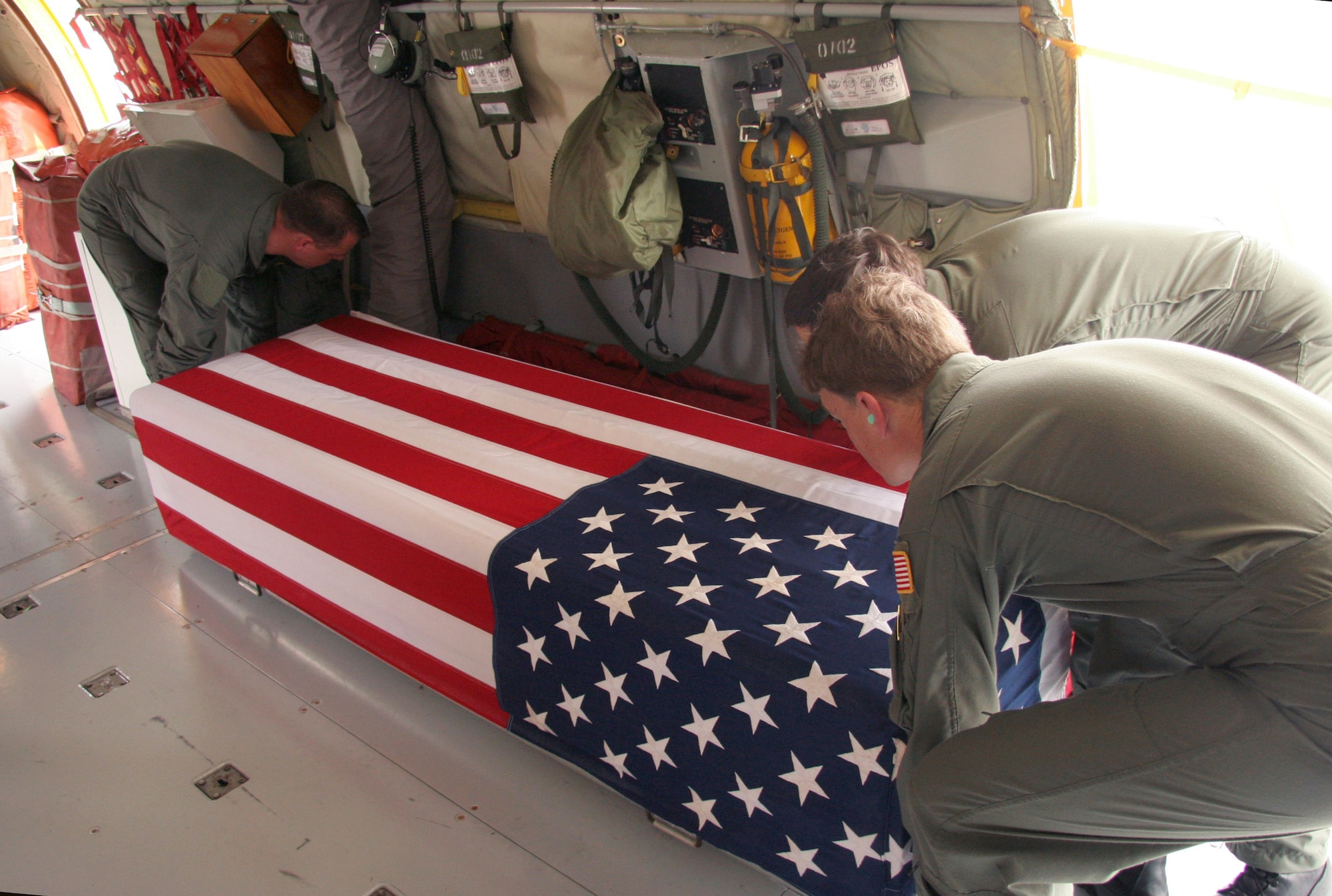 Reservists from the 939th Air Refueling Wing at Portland International Airport, Ore., secure remains of an unidentified servicemember in a KC-135 Stratotanker on Tuesday, April 18, 2006. The crew flew to Thailand to repatriate these remains to Hawaii. Once in Hawaii, the remains are now going through a process to be positively identified and returned to the family for burial. (U.S. Air Force photo/Maj. James R. Wilson)
